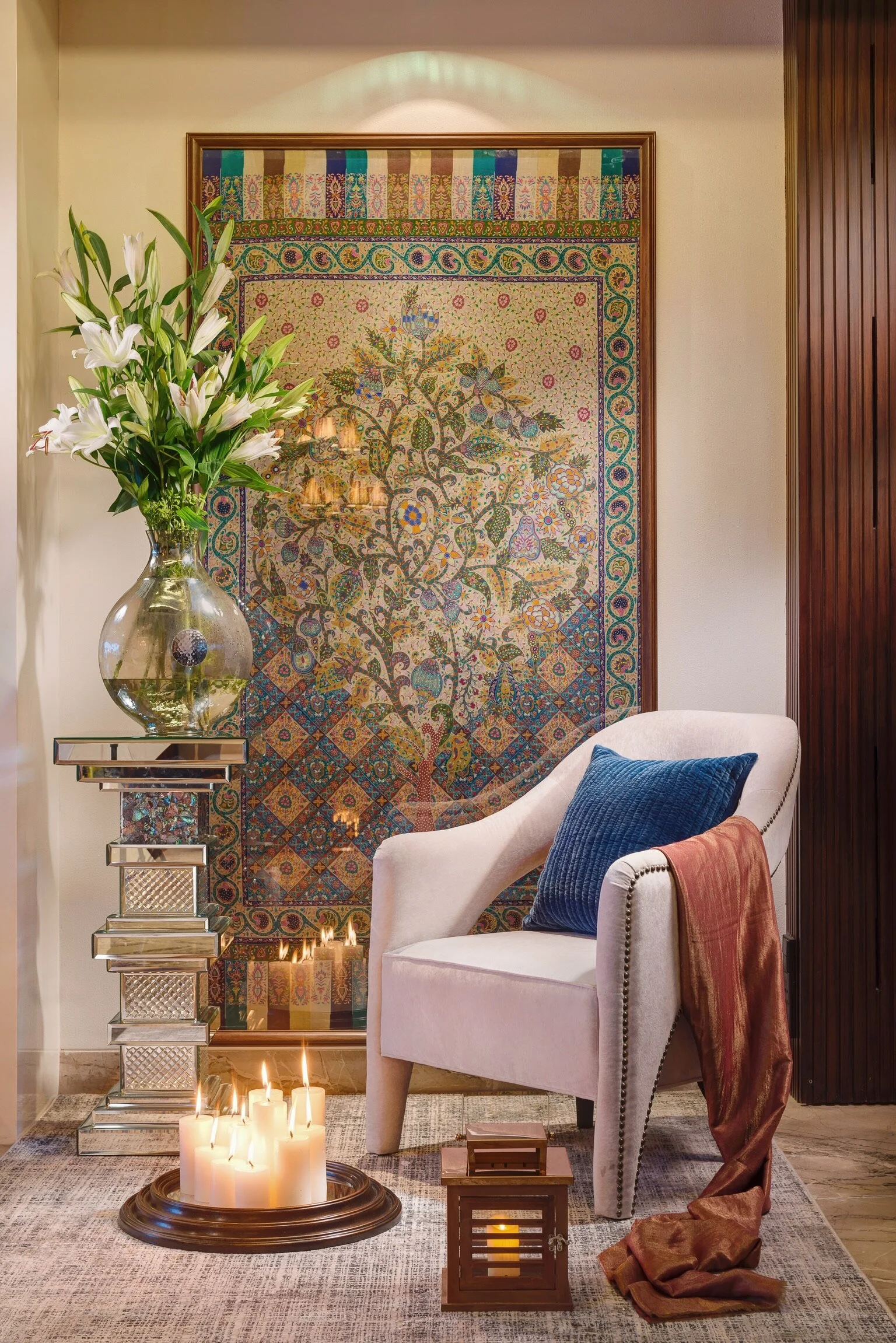 Entrances are perfect for creating striking vignettes. Instead of setting up a traditional rangoli pattern to greet guests, gather a collection of pillar candles for an unusual yet dramatic arrangement. While they cast a warm, shimmering glow standi…