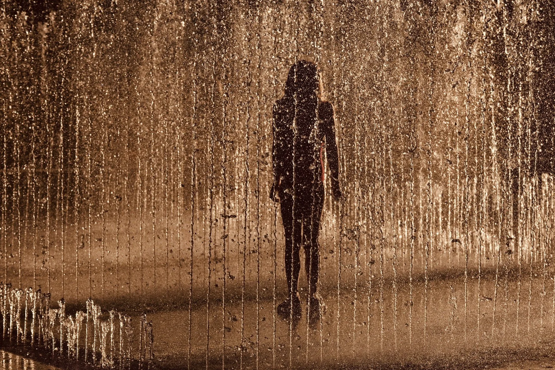 A girl enjoying the fountain at sunset in New York City.