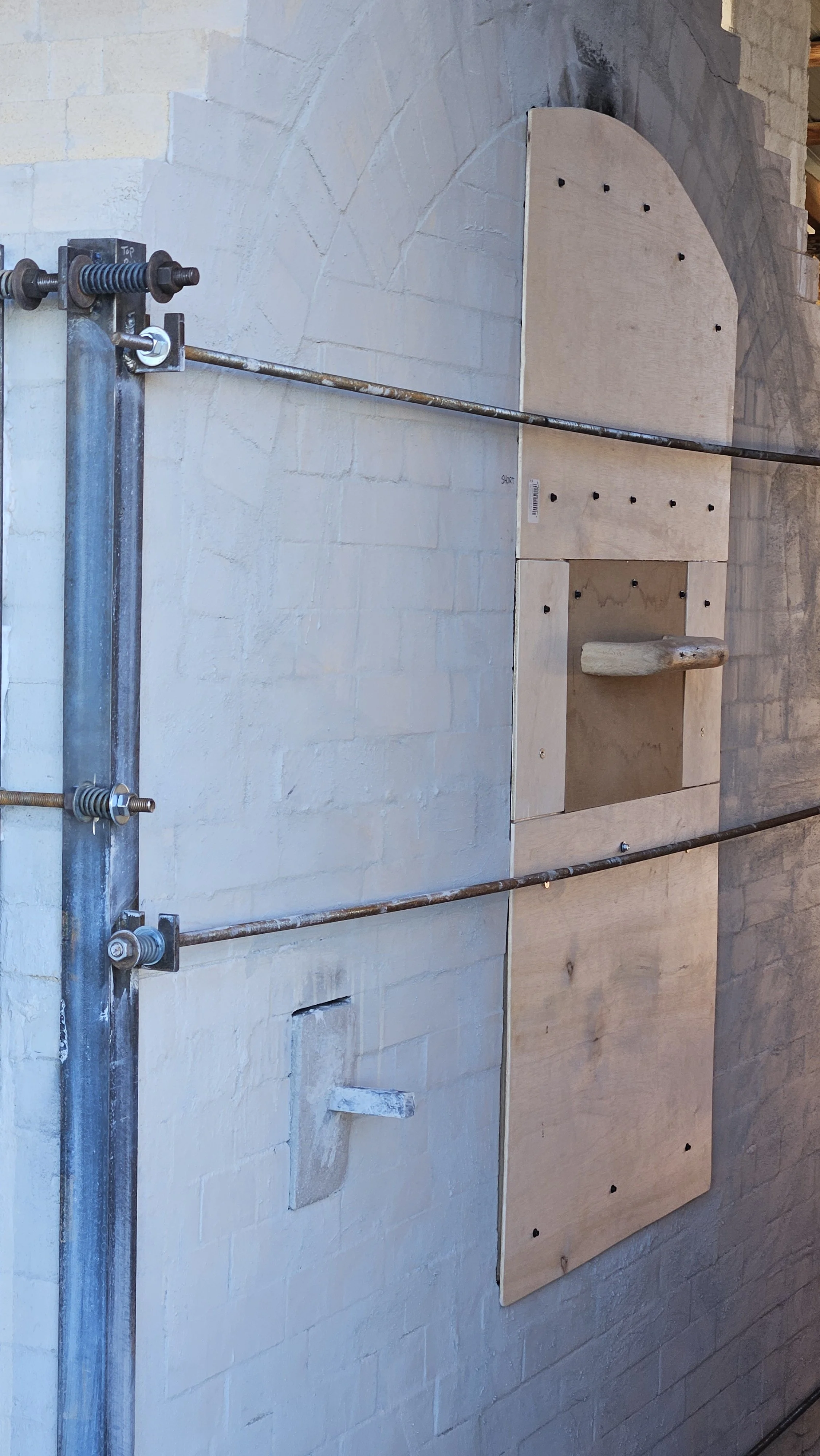 We built a custom fitted lightweight door (a dream!) made of rigid insulation faced on either side with thin plywood - to keep the interior closed when the kiln is not in use and to allow loading to take place over several days without worrying about