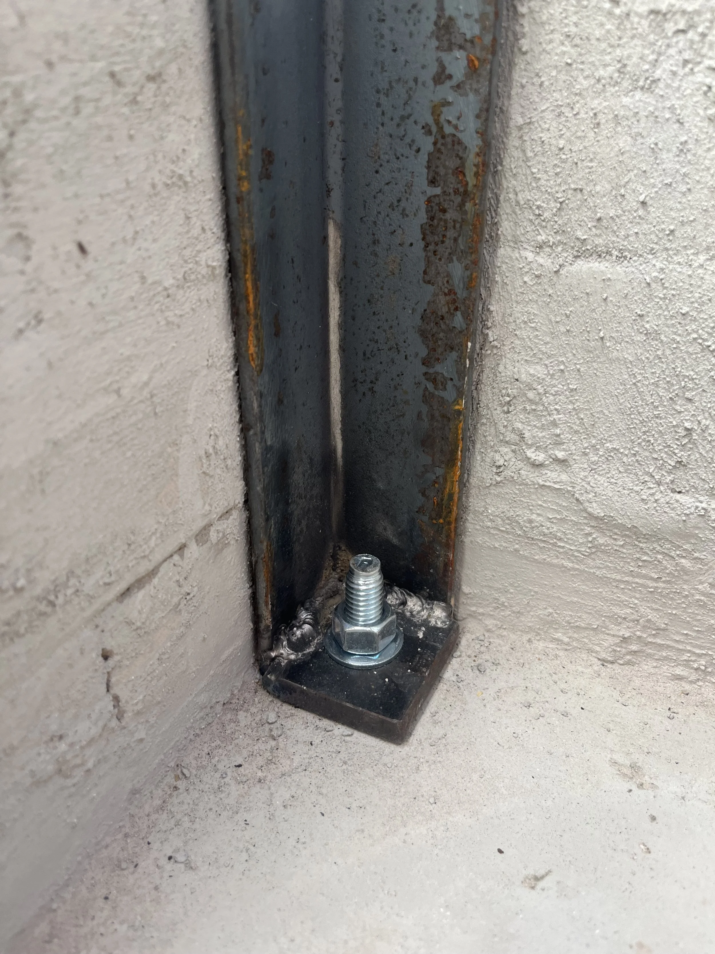 detail of steel frame anchored to concrete pad (-photo by Tori)