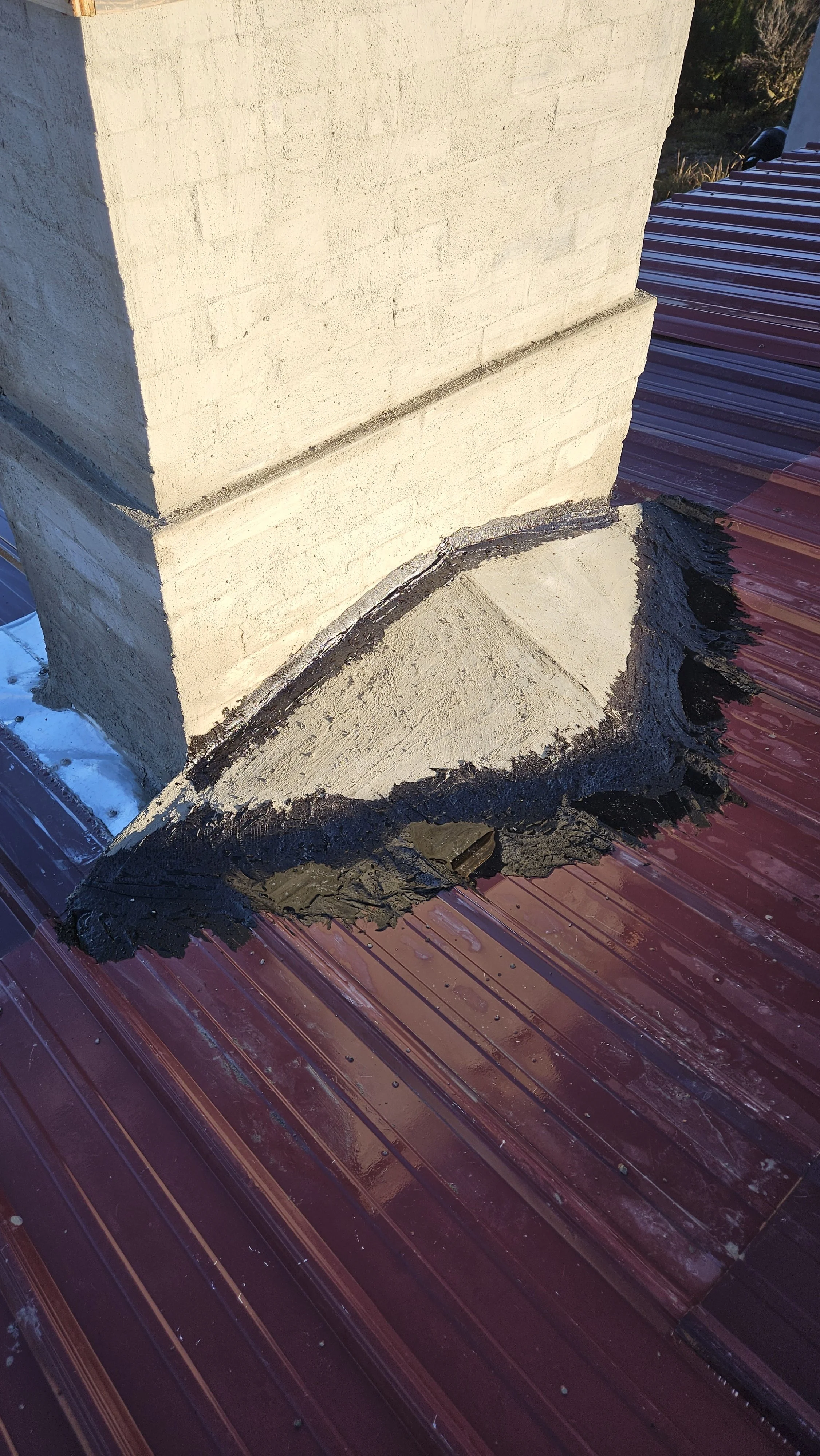 Chimney cricket tarred to prevent leaking.