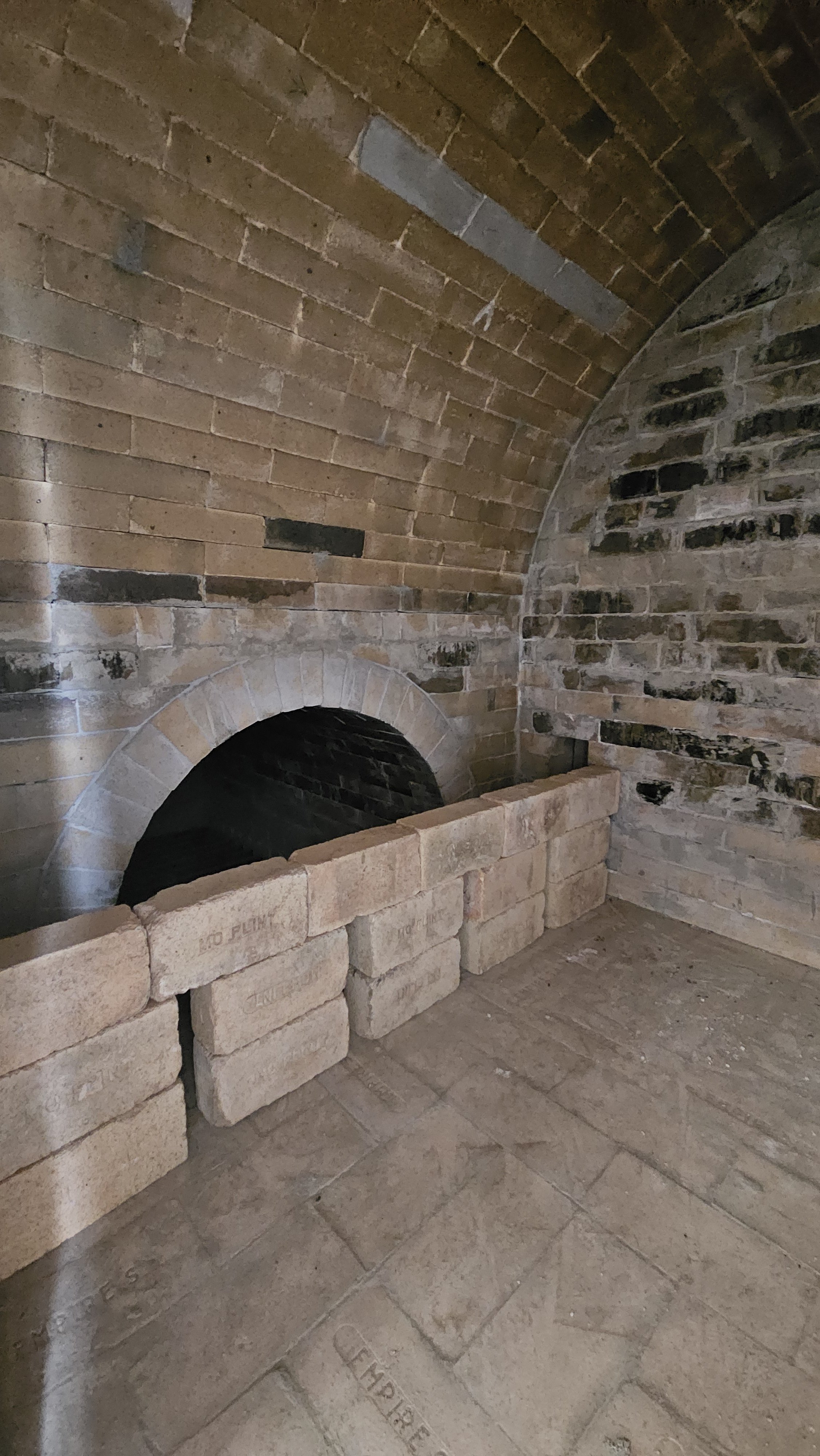 A non-structural bag wall was added after the kiln was complete.