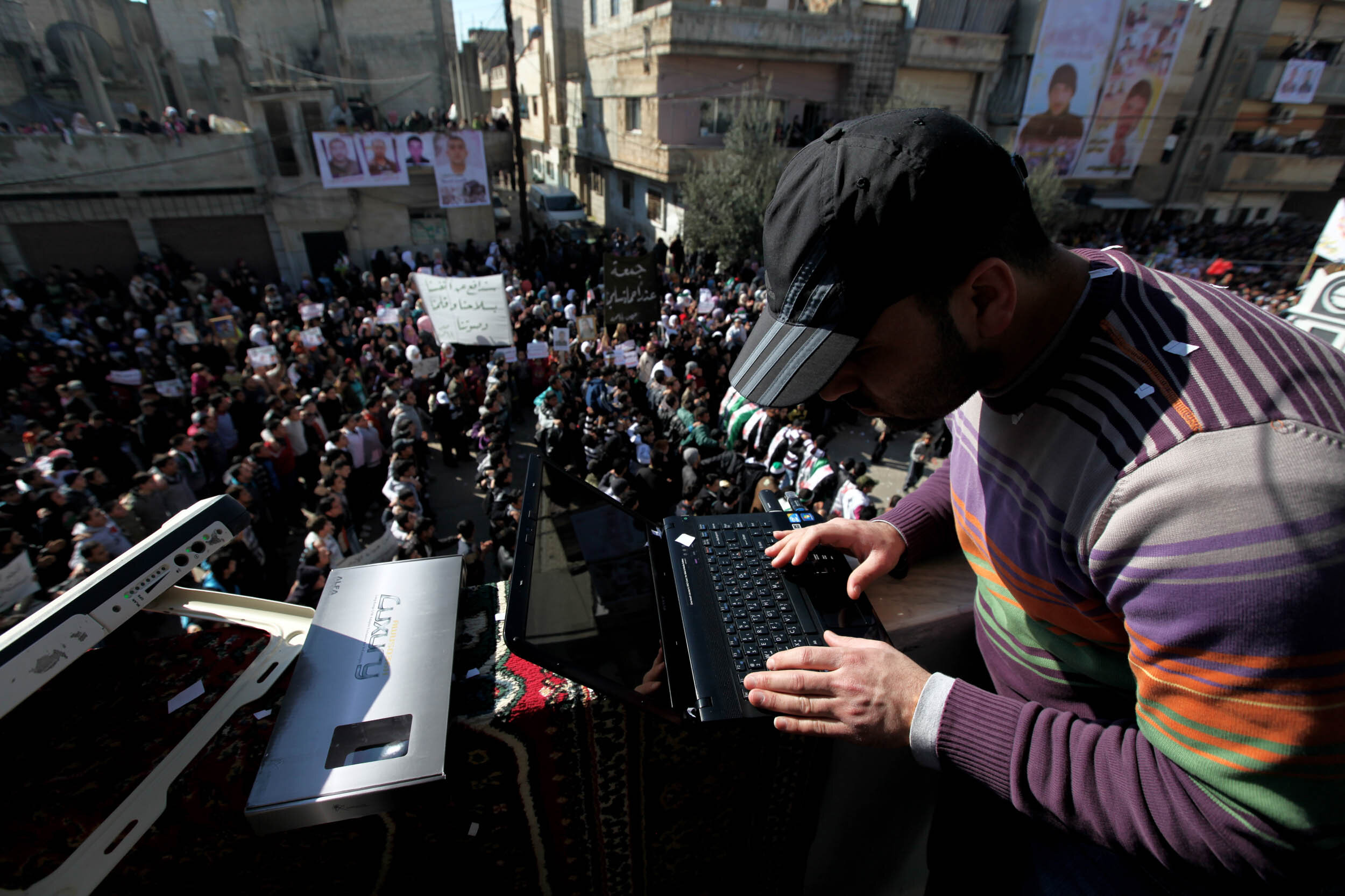  Activist sending his work to international media outlets at Friday protest, Baba Amer, Homs, Feb 03/2012.  