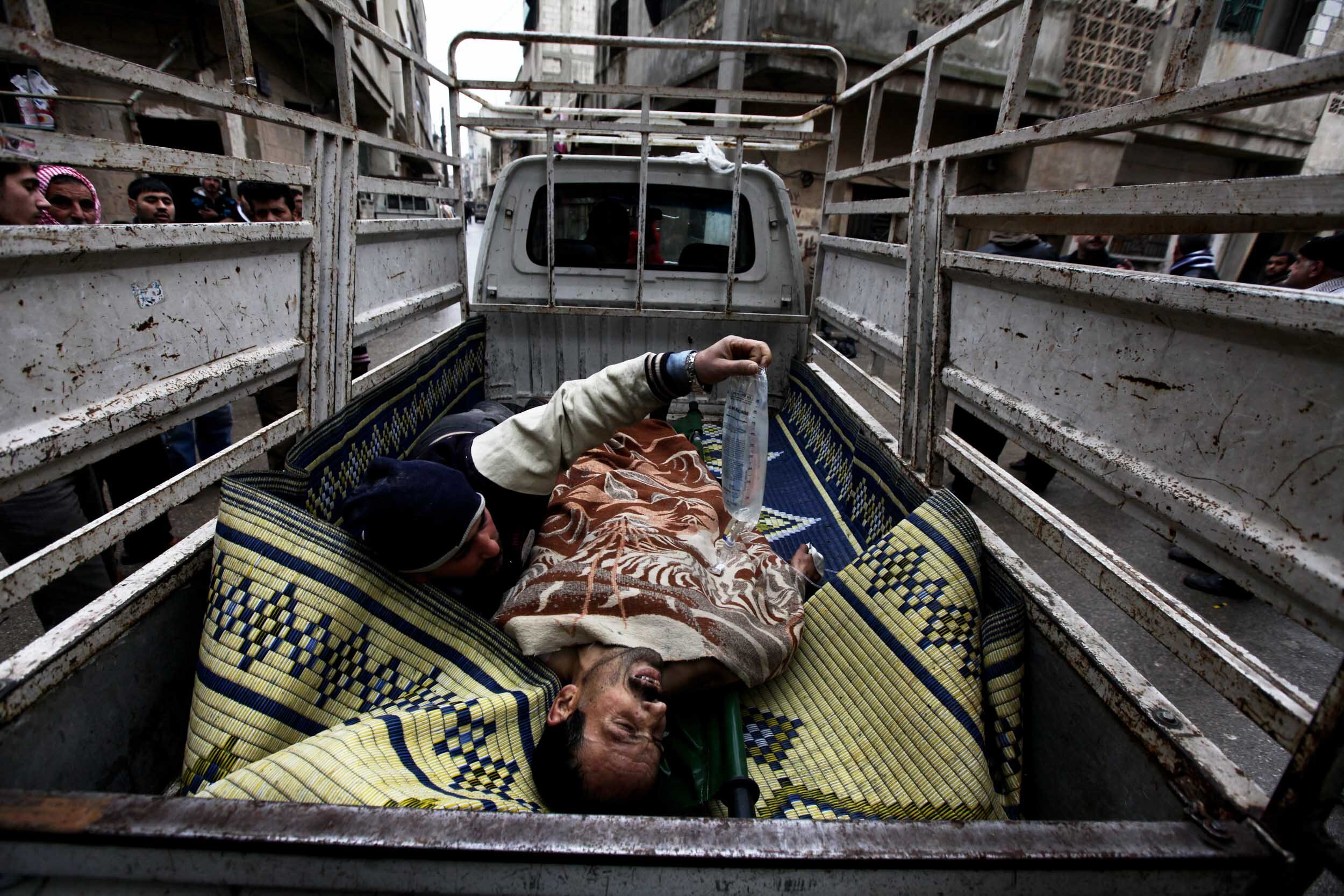  Evacuation of a victim of government sniper fire, Karm al-Zaitoune, Homs, Jan 26/2012.  