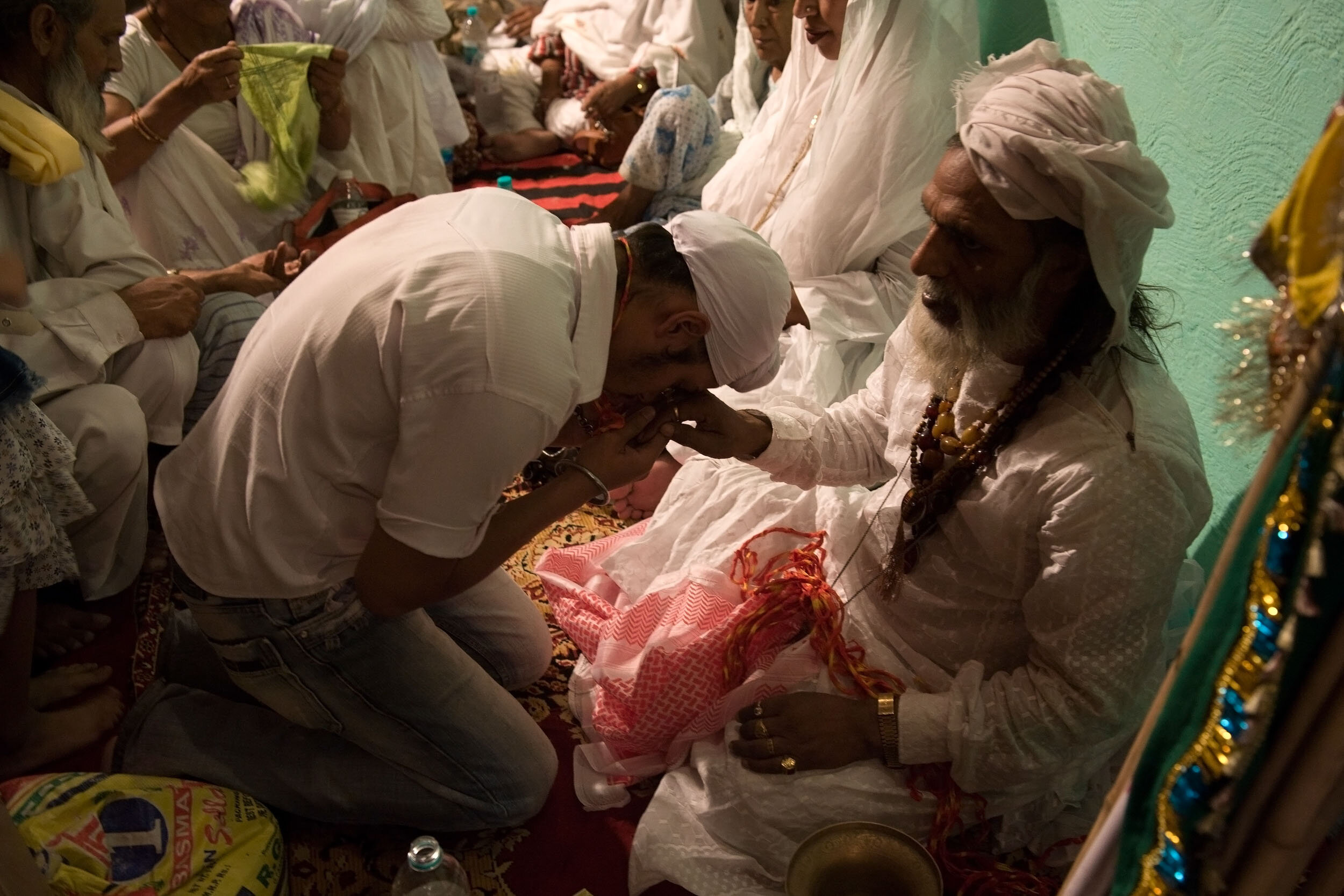  Young Sikh paying his respect to a Sufi  Baba , Delhi, May 28/2010. 