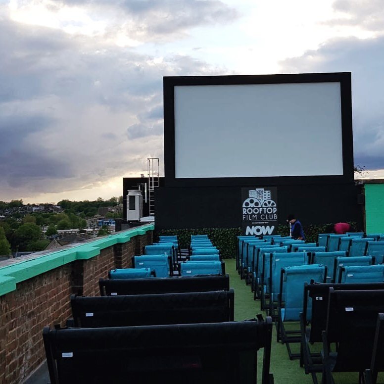 A new film screen designed for the @rooftopfilmclub on their Peckham site in london. Initially designed as a ballast only structure to resist storm events. Concerns over the performance of the asphalt roof finish meant we had to add to the design to 