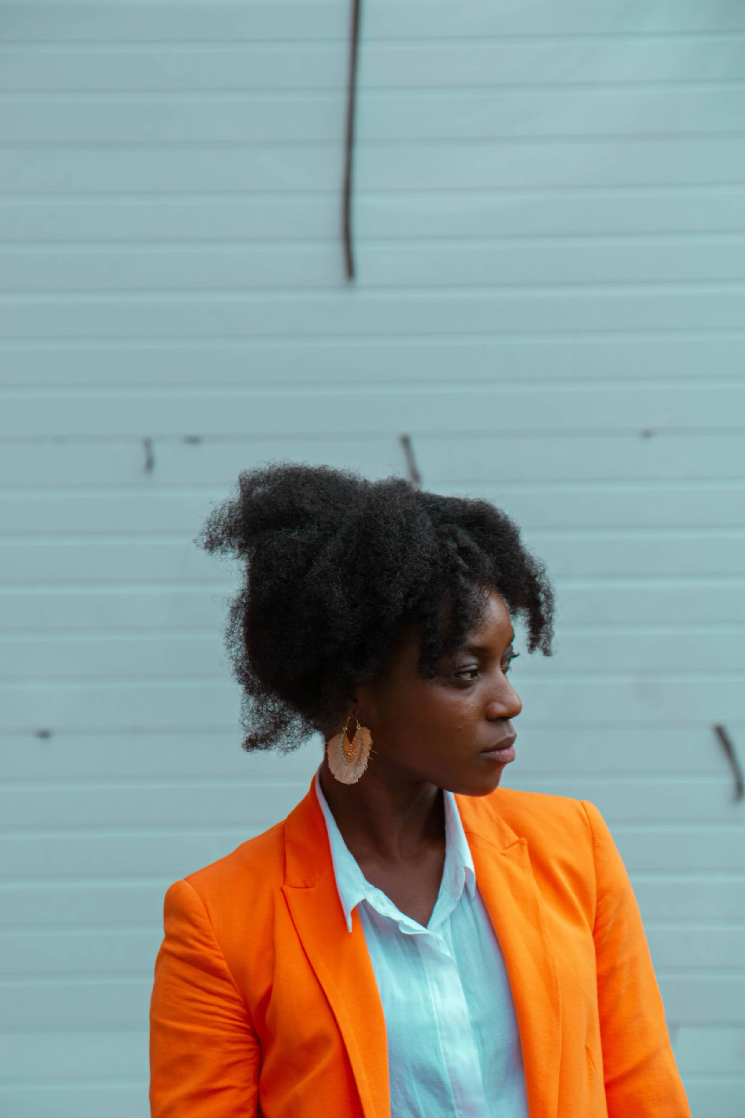 Frustrated woman in an orange blazer.