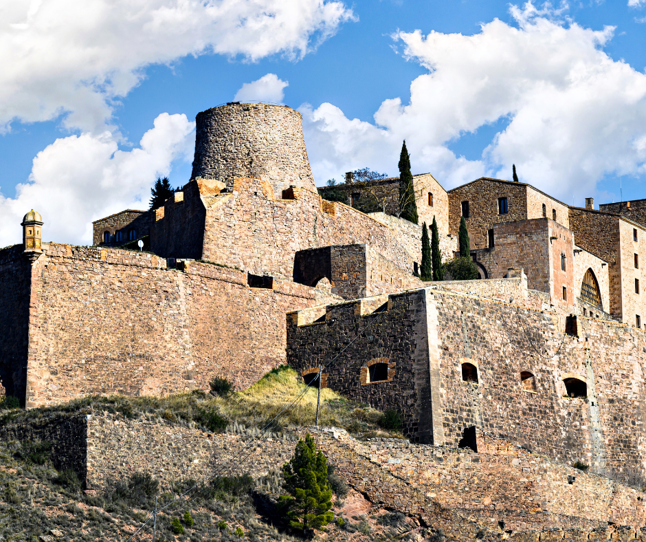 Cardona Castle, a large stone structure in Spain, stands majestically in a less-visited region, rich in history.