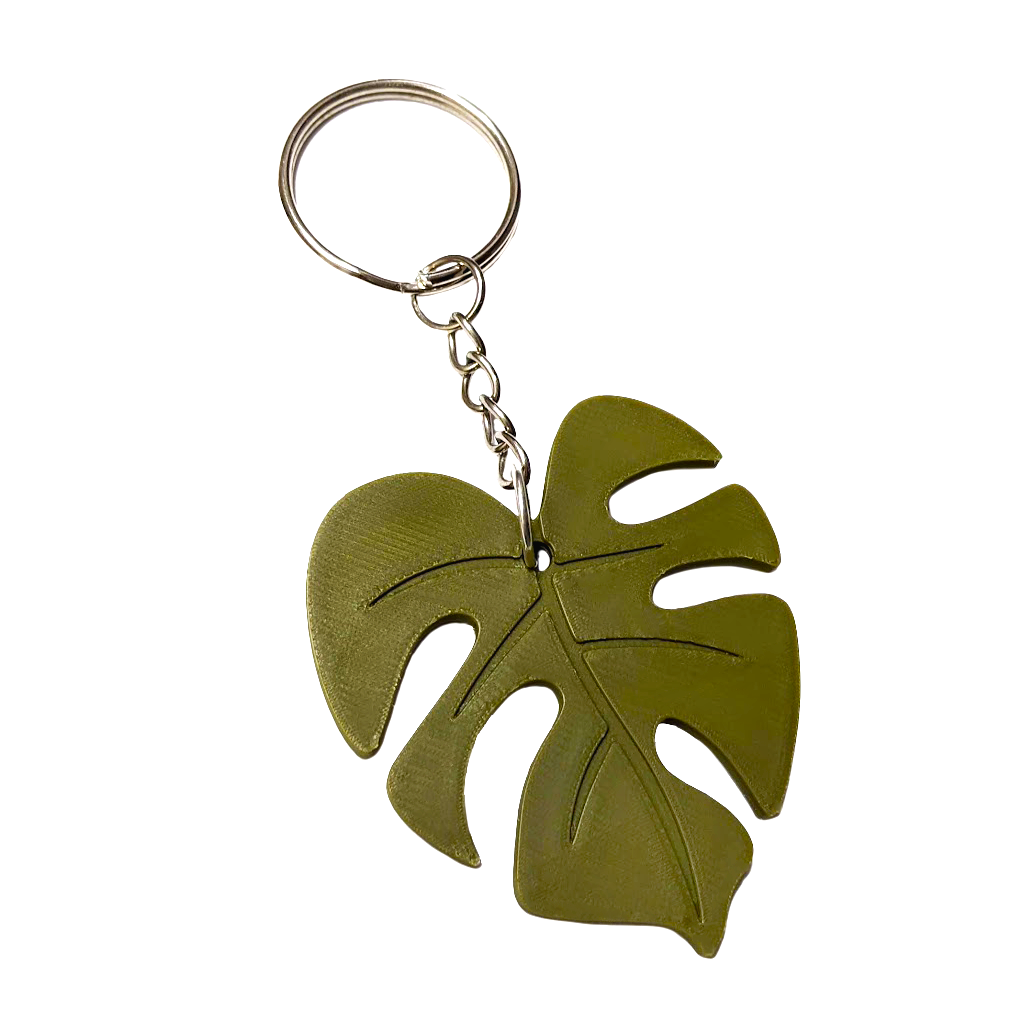 Keychain with a plastic Monstera leaf design attached to a metal chain and keyring.