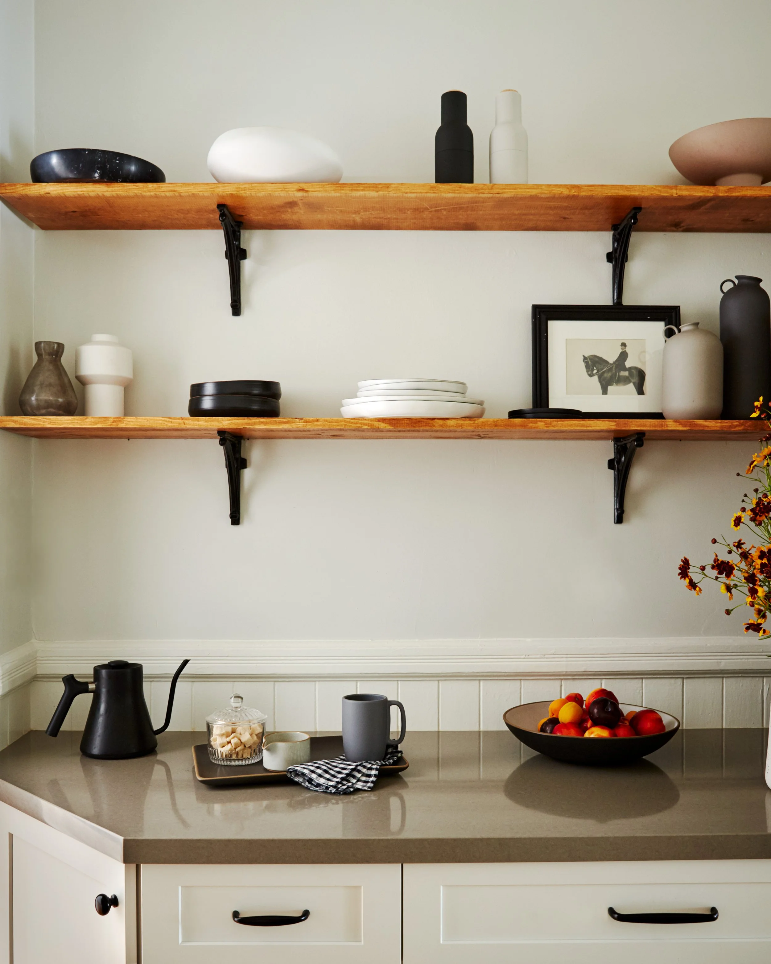 Presidio Heights kitchen with wall shelves, wainscot, shelves filled with plates, bowls, and artwork, tea, and cabinetry