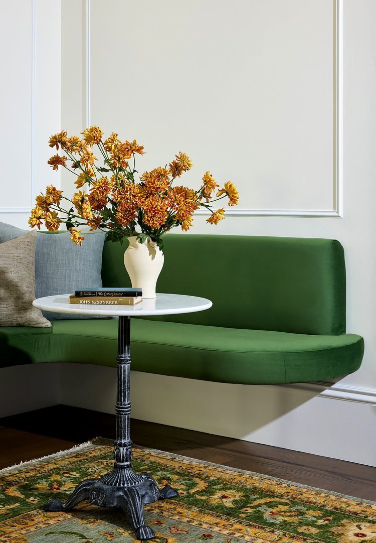 A round side table with a black decorative base