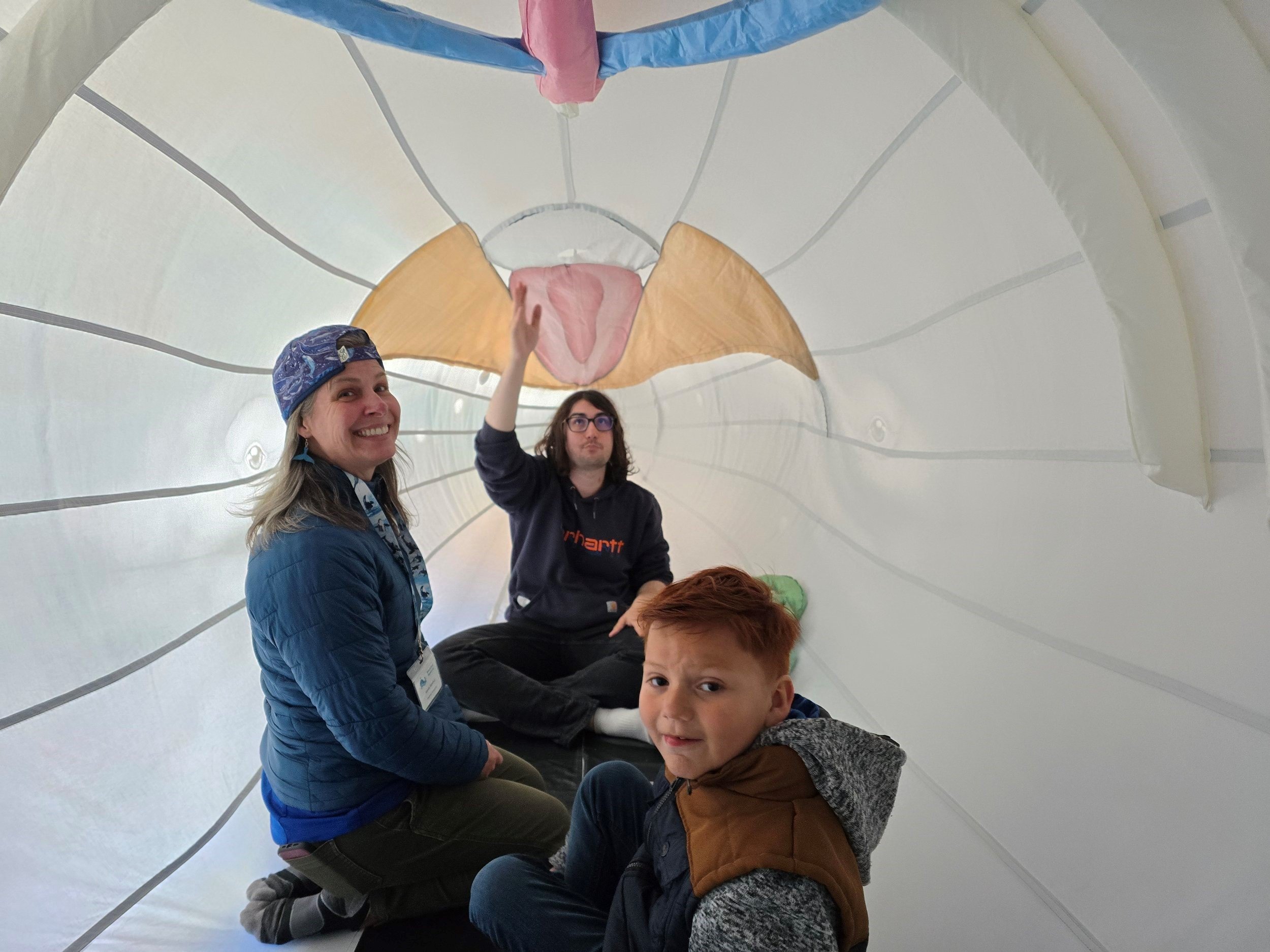 People inside a large inflatable whale model