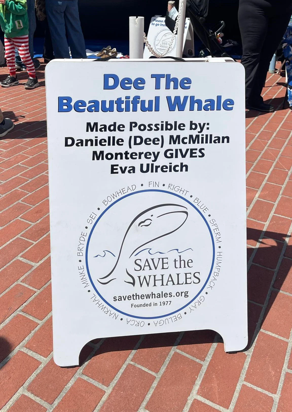 Sign say Dee The Beautiful Whale Made Possible by Danielle (Dee) McMillan Monterey Gives Eva Ulreich