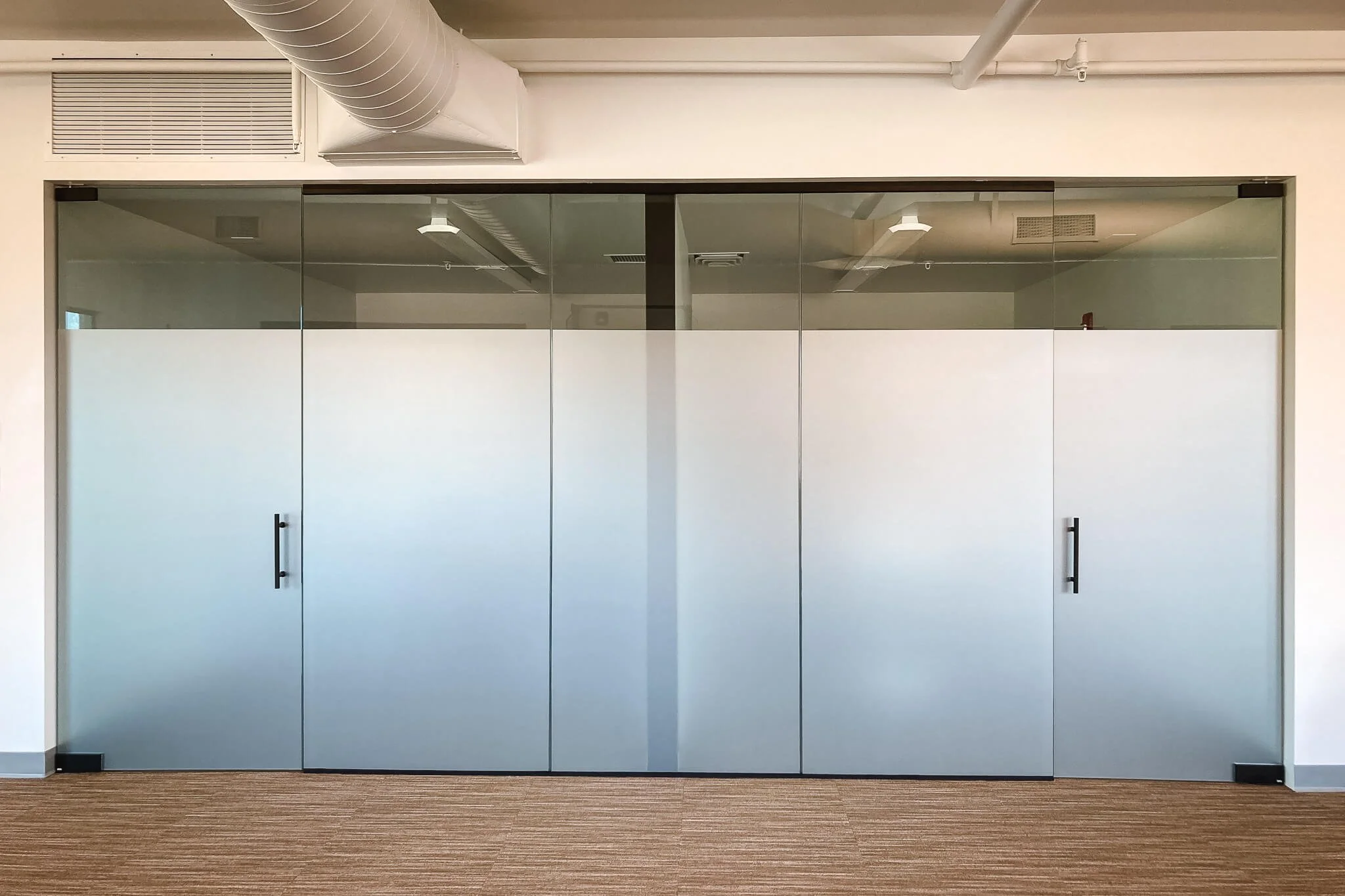 Full-height gradient frosted window graphics installed on interior glass doors and panels for conference room privacy with a sleek, modern finish.