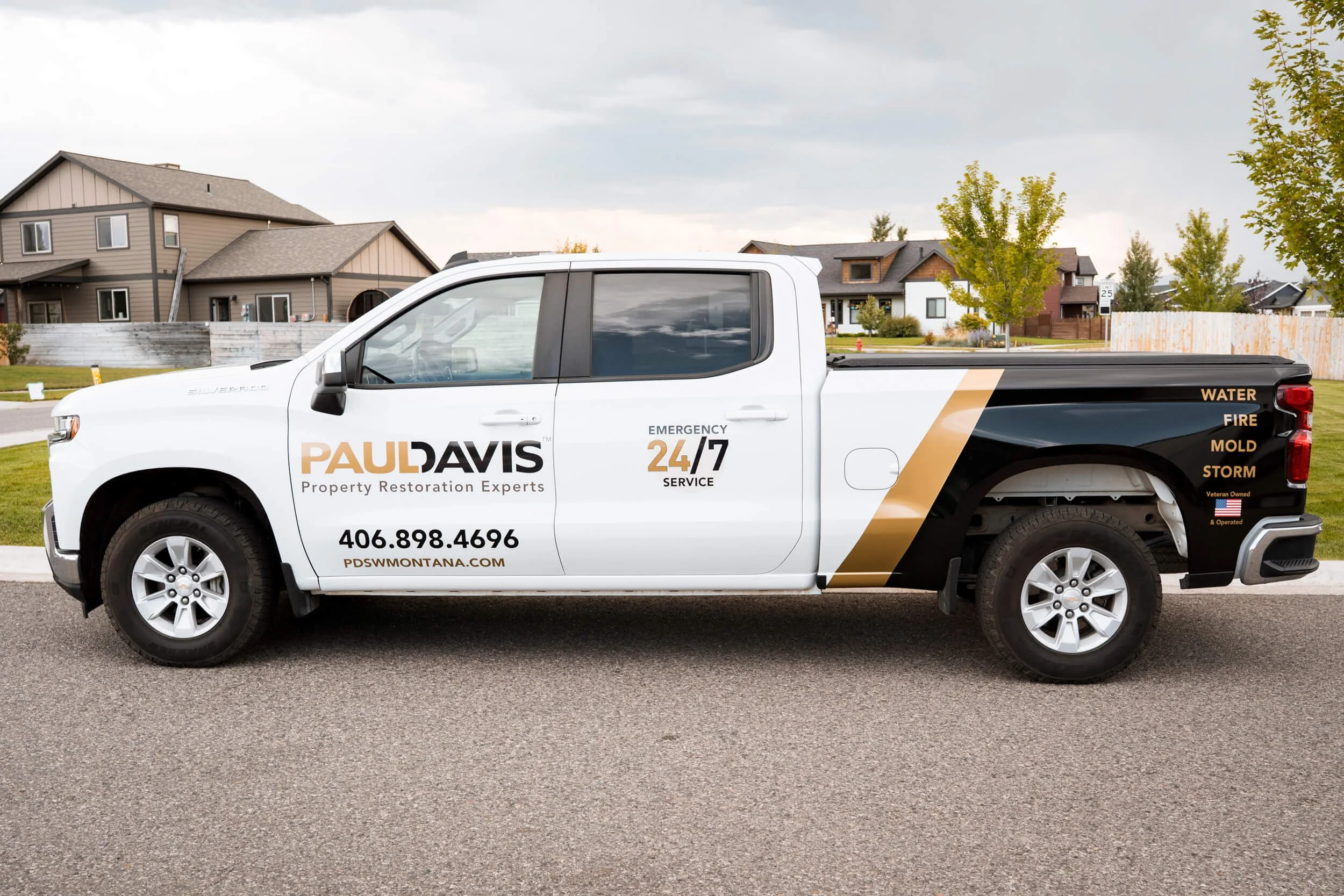Eye-catching fleet graphics for Paul Davis Restoration in Bozeman, MT, featuring a combo of metallic gold and gloss black