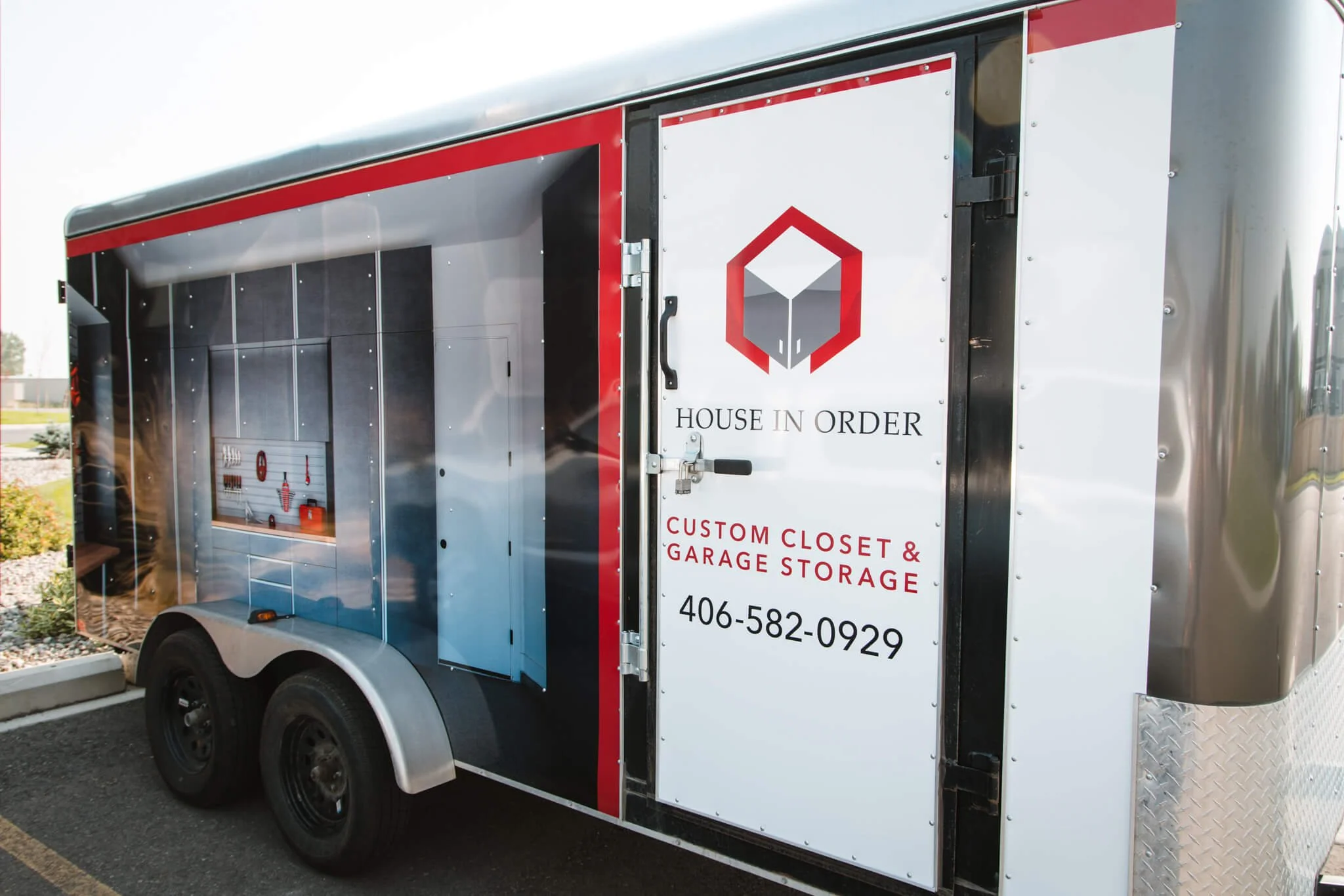Side trailer wrap for House in Order in Bozeman, Montana, featuring realistic garage interior graphics paired with branding and phone number