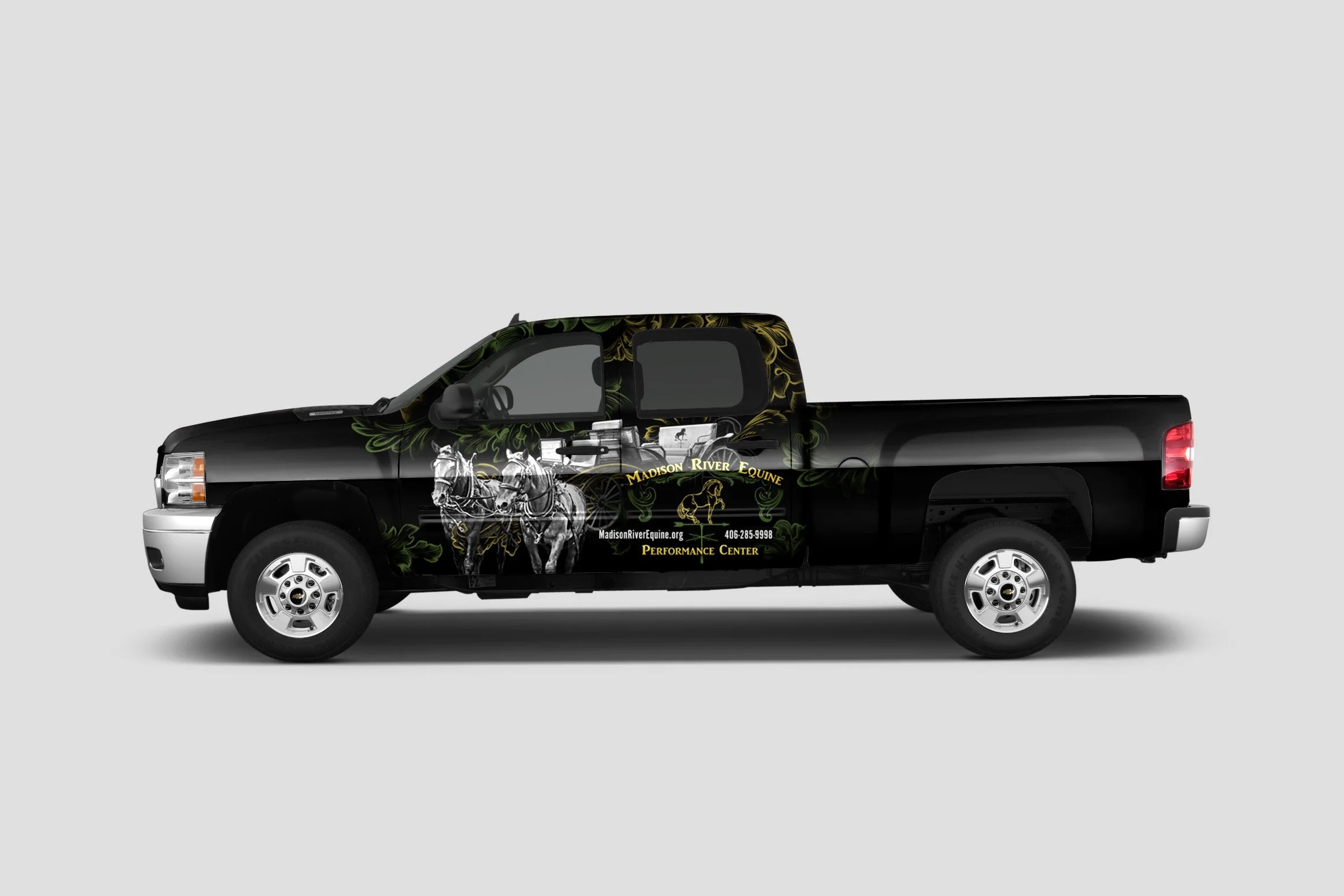 Black pickup truck with Madison River Equine advertising, featuring horses and wagon graphics on the side.