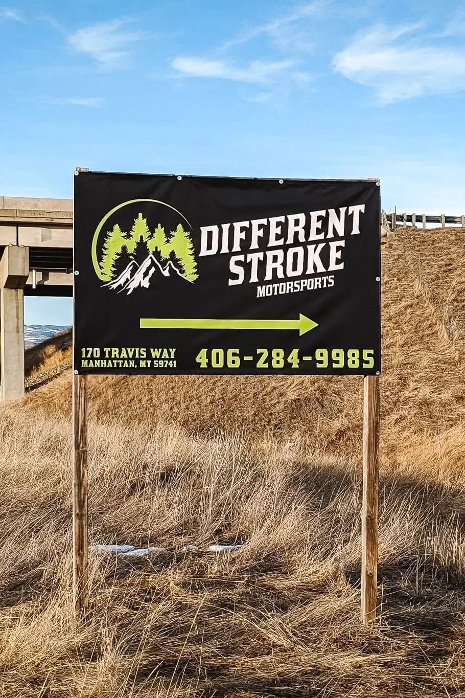 Weatherproof roadside Bozeman custom sign for Different Stroke Motorsports in Manhattan, Montana, directing customers with bold green and white branding.