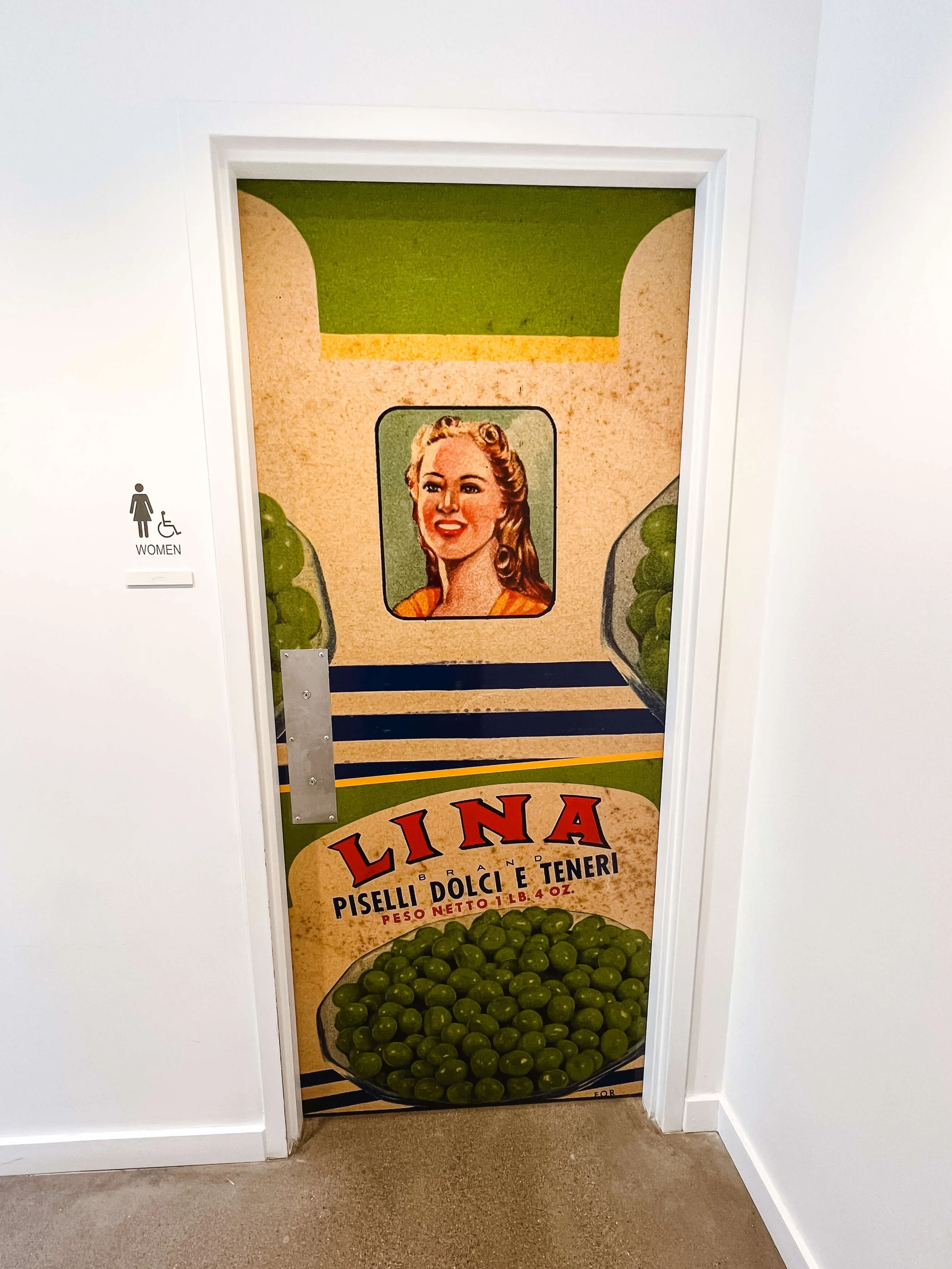 Custom vinyl wrap replicating a vintage Lina canned peas label, applied to a door for a creative and nostalgic look that blends branding with interior decor.