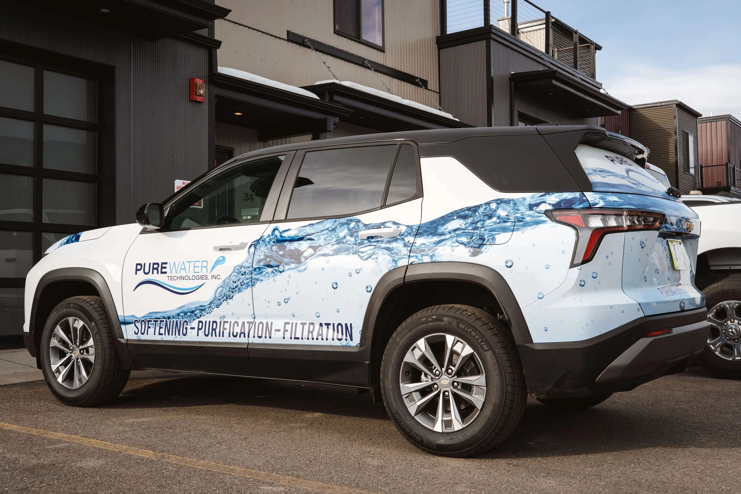 Bubbly water vinyl wrap covering the bottom half of a Chevy Equinox, also includes Pure Water logo and branding