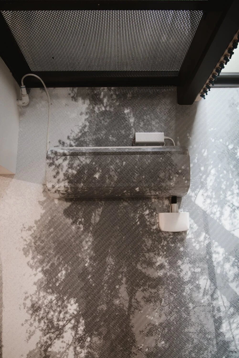 Close-up view of a grayscale wall wrap featuring a textured tree canopy design, blending artistic detail with architectural elements in Bozeman, MT.