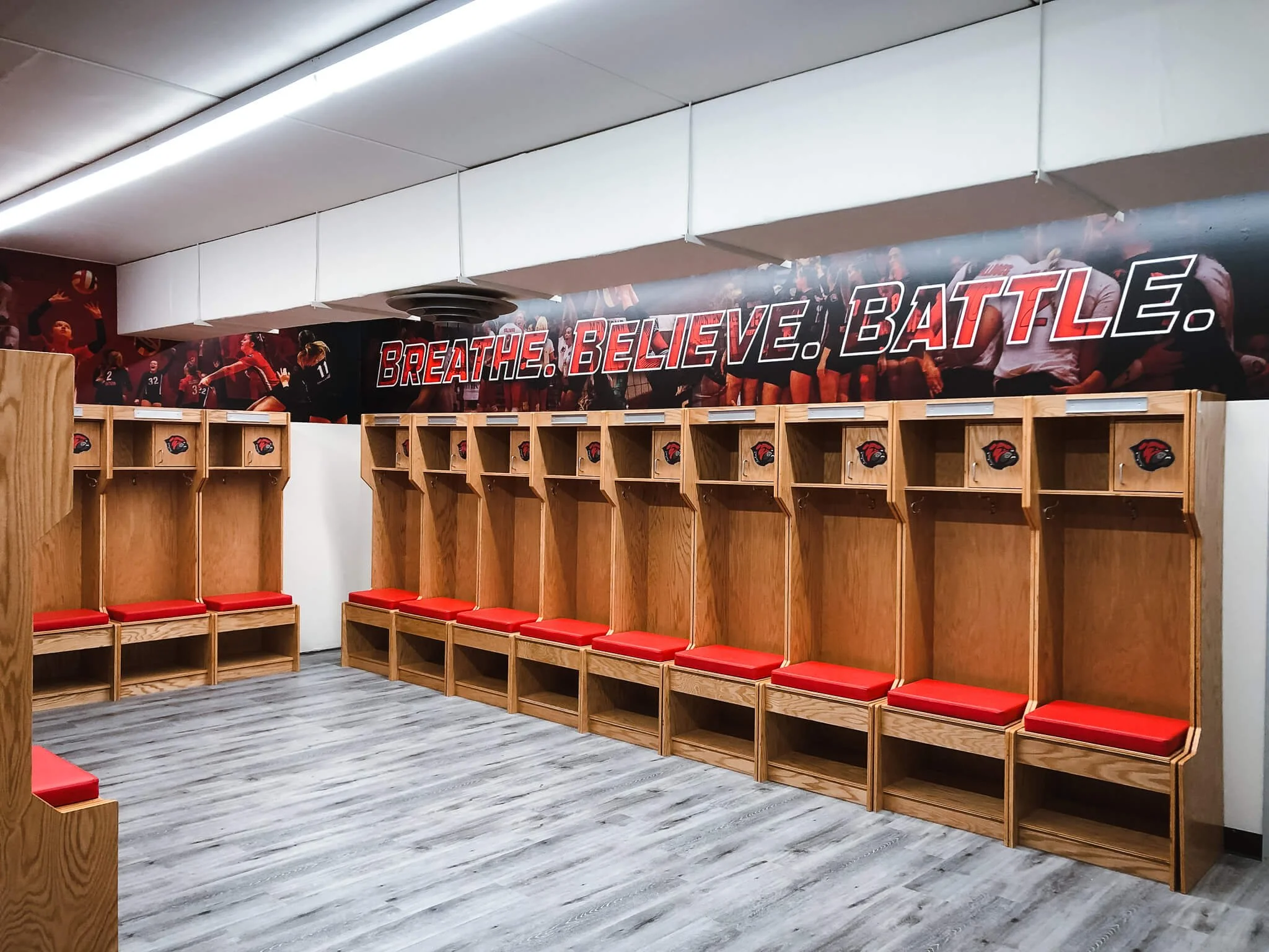 Montana Western Women's Volleyball locker room wall wrap with Breath. Believe. Battle text on photo composite background.