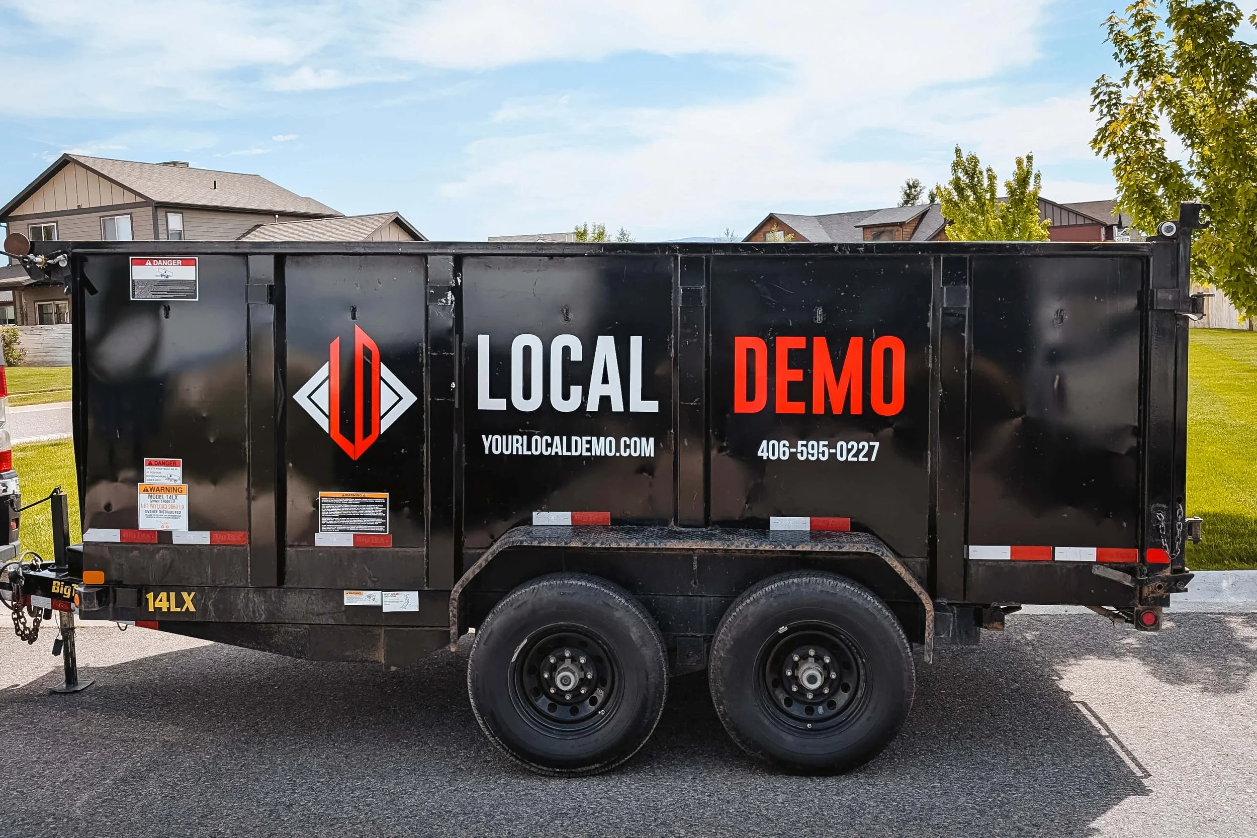 Dump trailer with Local Demo vinyl spot graphics on the side
