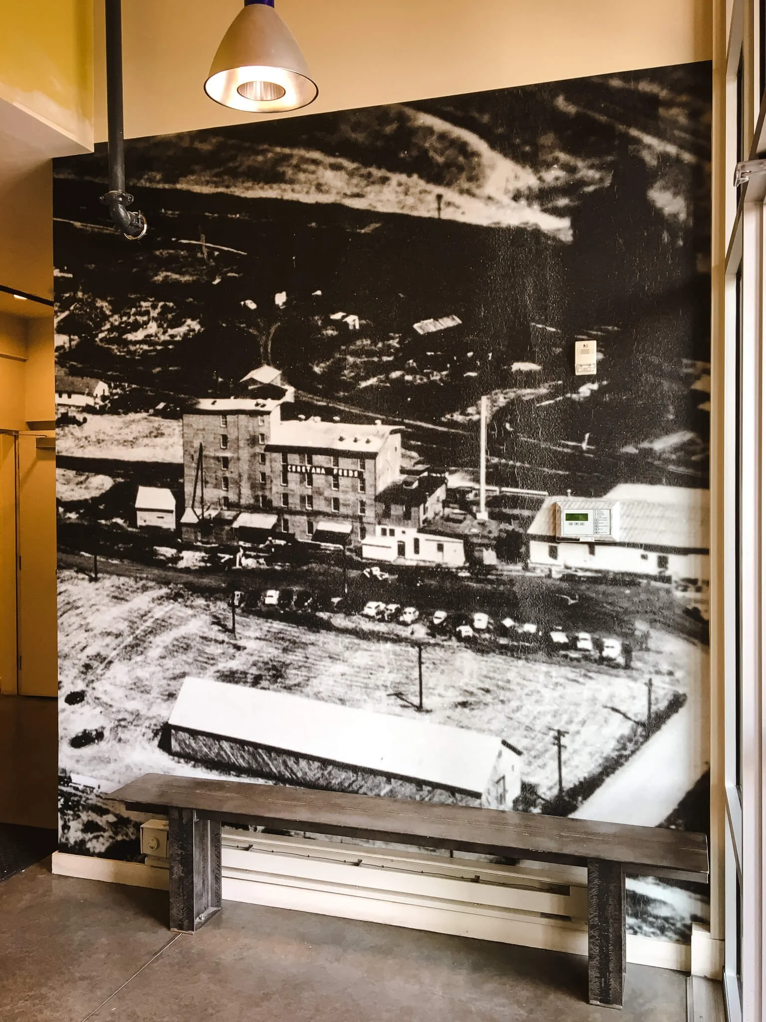 Wall wrap showcasing a historical photo of an aerial view of old canning buildings in the Cannery District in Bozeman, Montana.