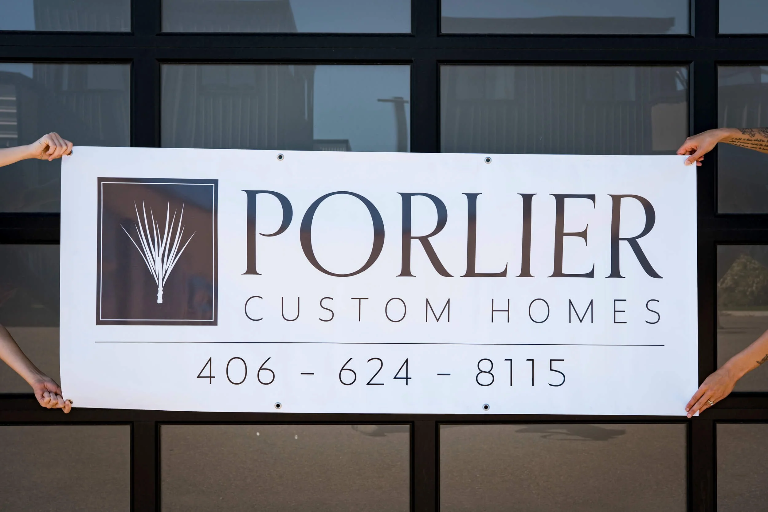 Porlier Custom Homes dark grey logo on a white background banner