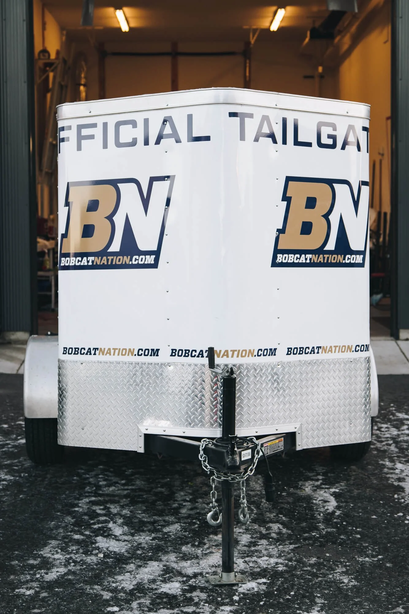 Front view of a Bobcat Nation trailer in Bozeman, Montana, with custom trailer graphics displaying "Official Tailgate" branding and multiple instances of the BN logo for game day marketing.