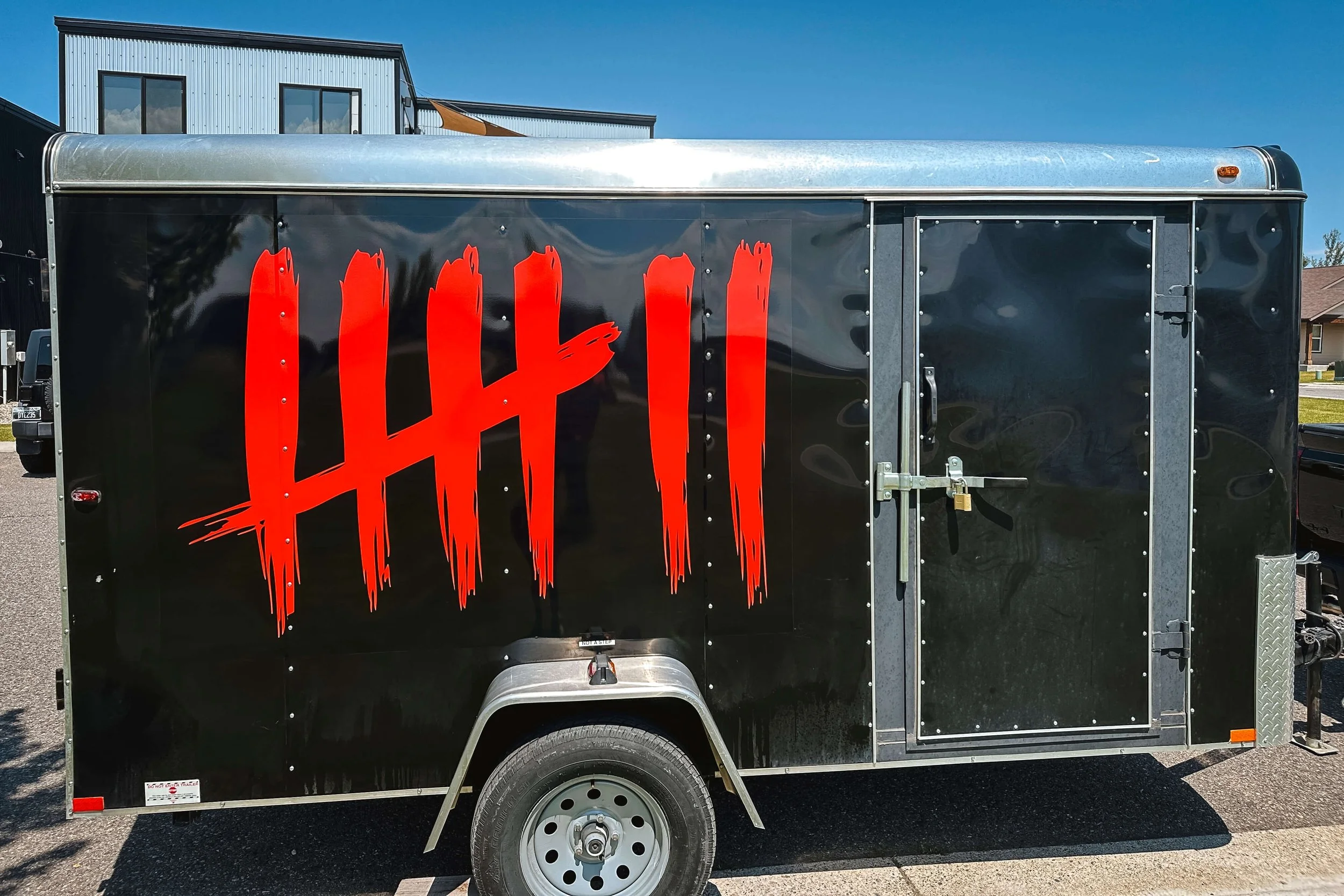Eye-catching red vinyl graphic for Seven Sushi on the side of a black trailer
