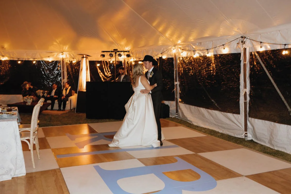 Custom monogrammed dance floor wrap with initials 'R&B' during a tented wedding reception at 320 Guest Ranch, Gallatin Gateway, MT. Styled by Golden Hour Events, photo by Danielle Mullens Photography.