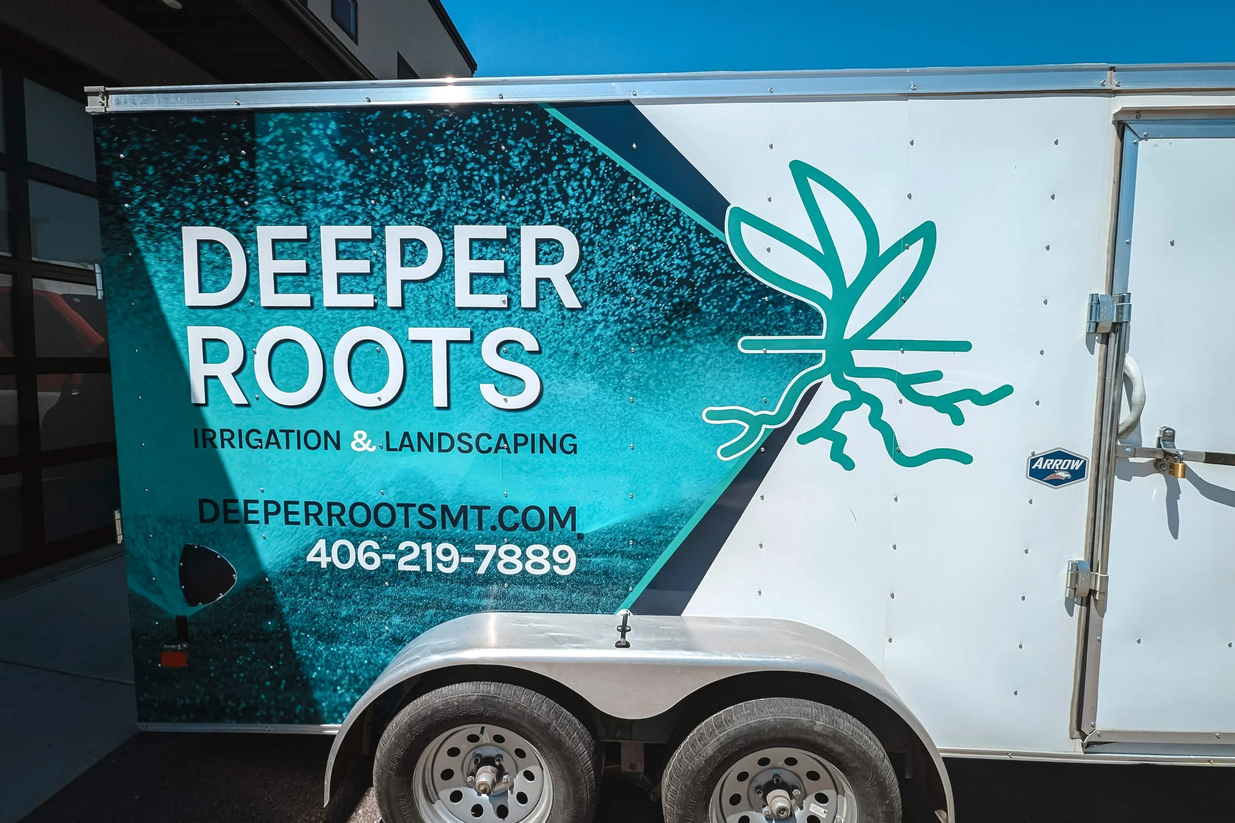Teal and navy partial trailer wrap for Deeper Roots Irrigation and Landscaping of Bozeman, MT