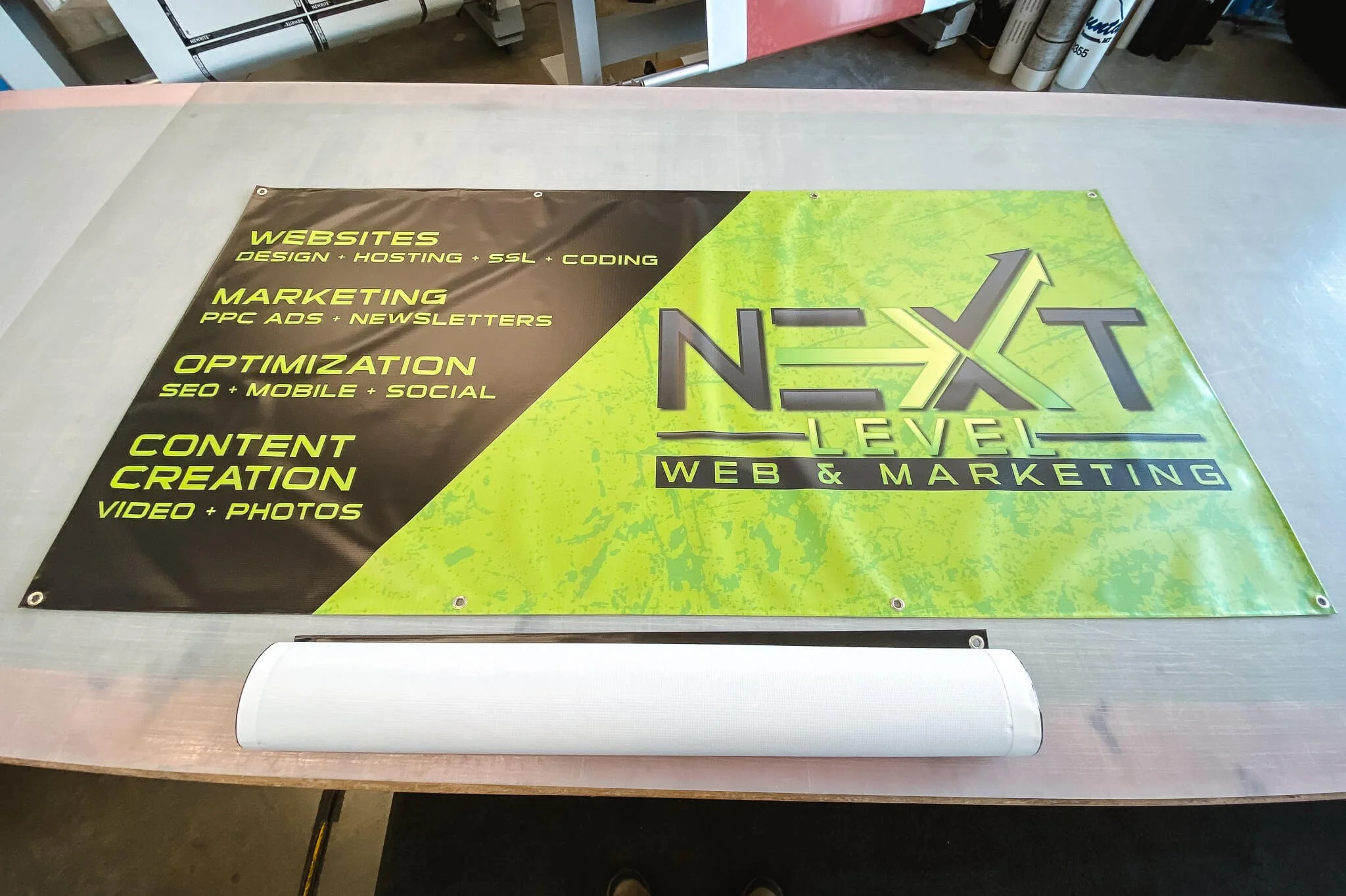 High-impact green and black vinyl banner for Next Level Web & Marketing listing services like SEO, PPC, and content creation.