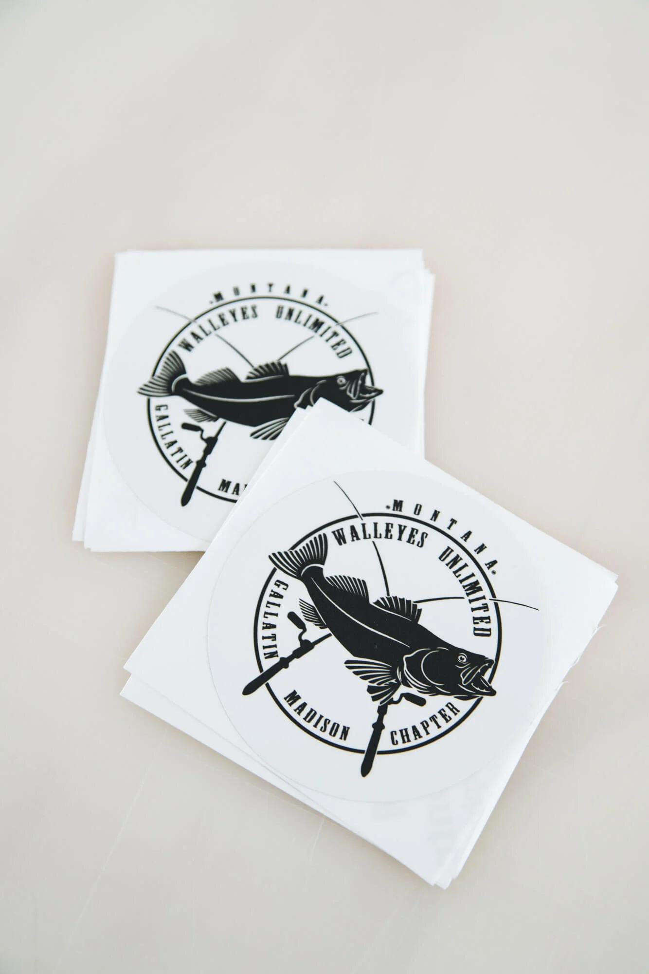 Custom fishing stickers printed with detailed black-and-white artwork.