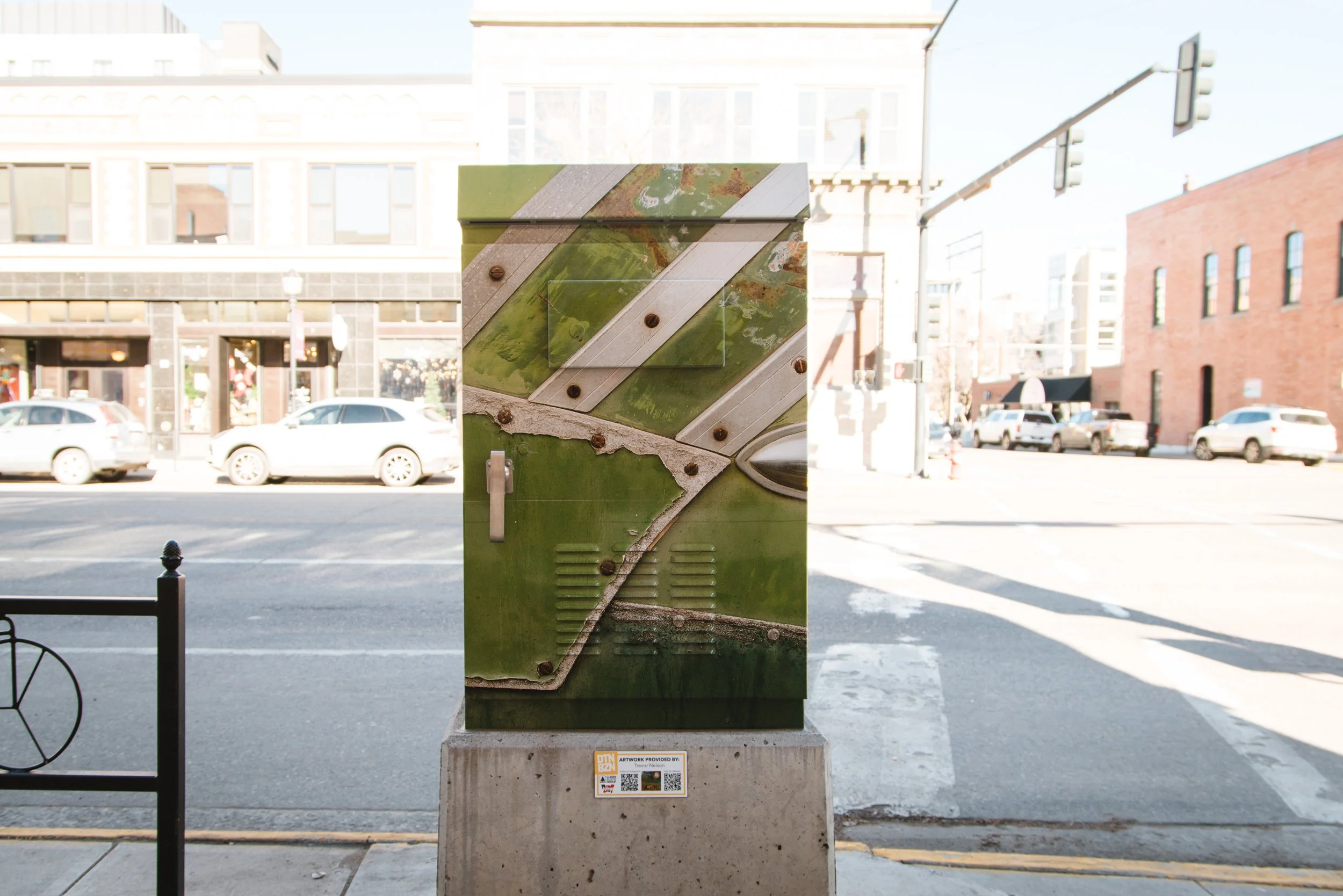 Vinyl Wrap Utility Boxes featuring a vibrant geometric art design installed on a traffic box in a public space.
