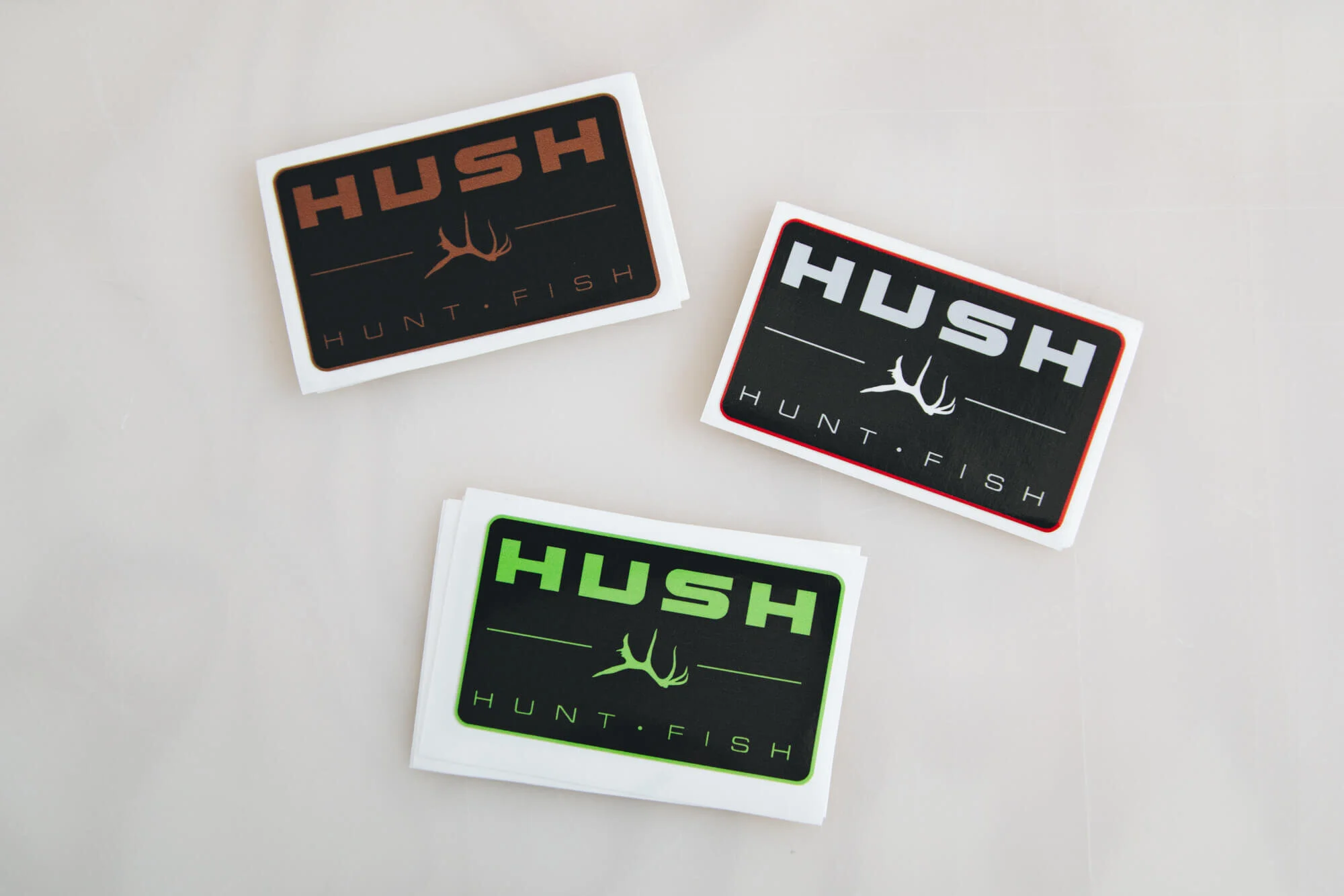 Custom HUSH stickers printed in multiple colors.