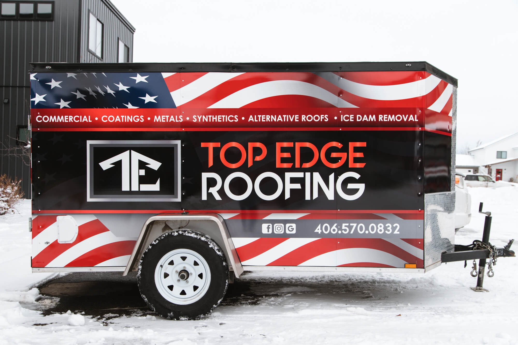 Custom trailer graphics for Top Edge Roofing in Bozeman, Montana, with American flag design, bold branding, and service offerings like commercial coatings and alternative roofs.