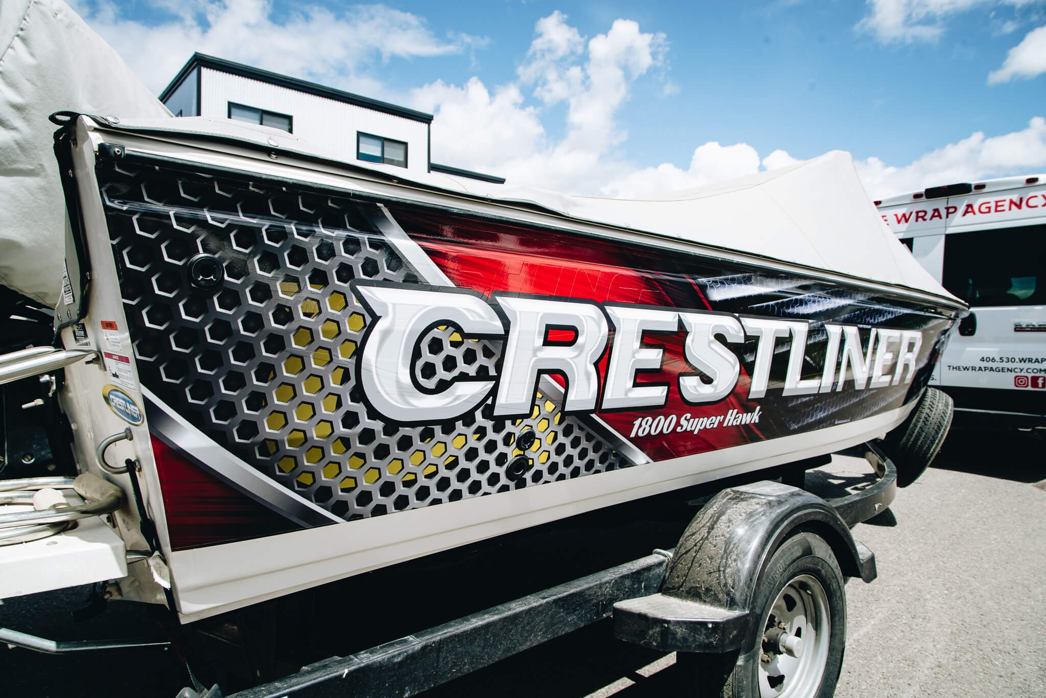 Close-up view of the Crestliner boat’s rear section with a custom vinyl wrap showcasing metallic honeycomb textures and dynamic color accents.