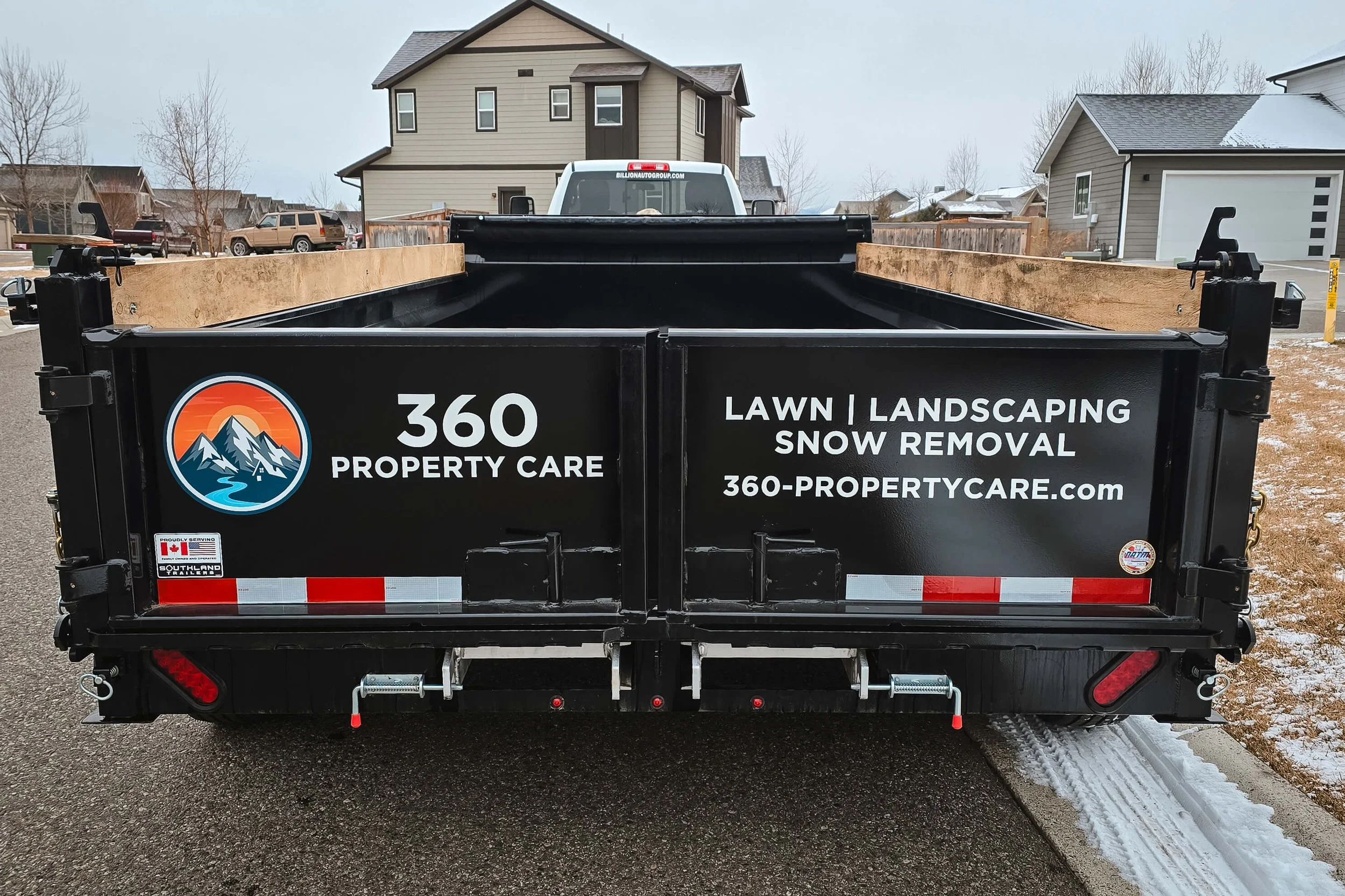 Back view of a dump trailer with vinyl spot graphics on each of the half doors in Bozeman, Montana