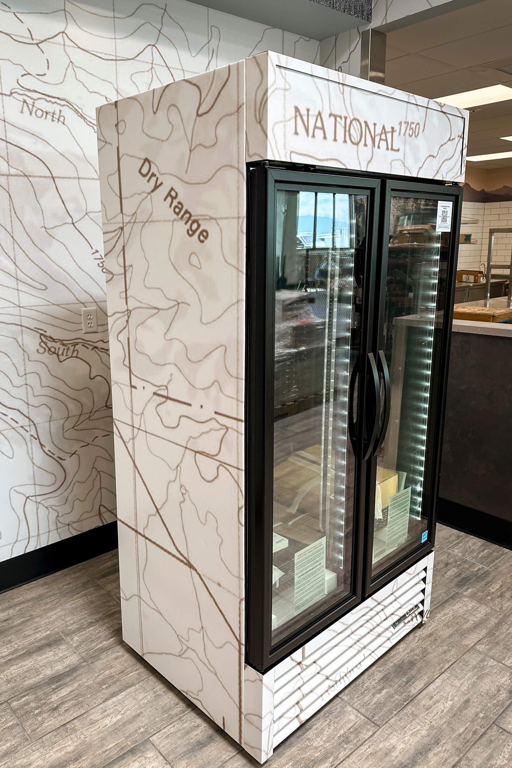 Commercial refrigerator wrapped with a sepia toned topographic map of Yellowstone National Park