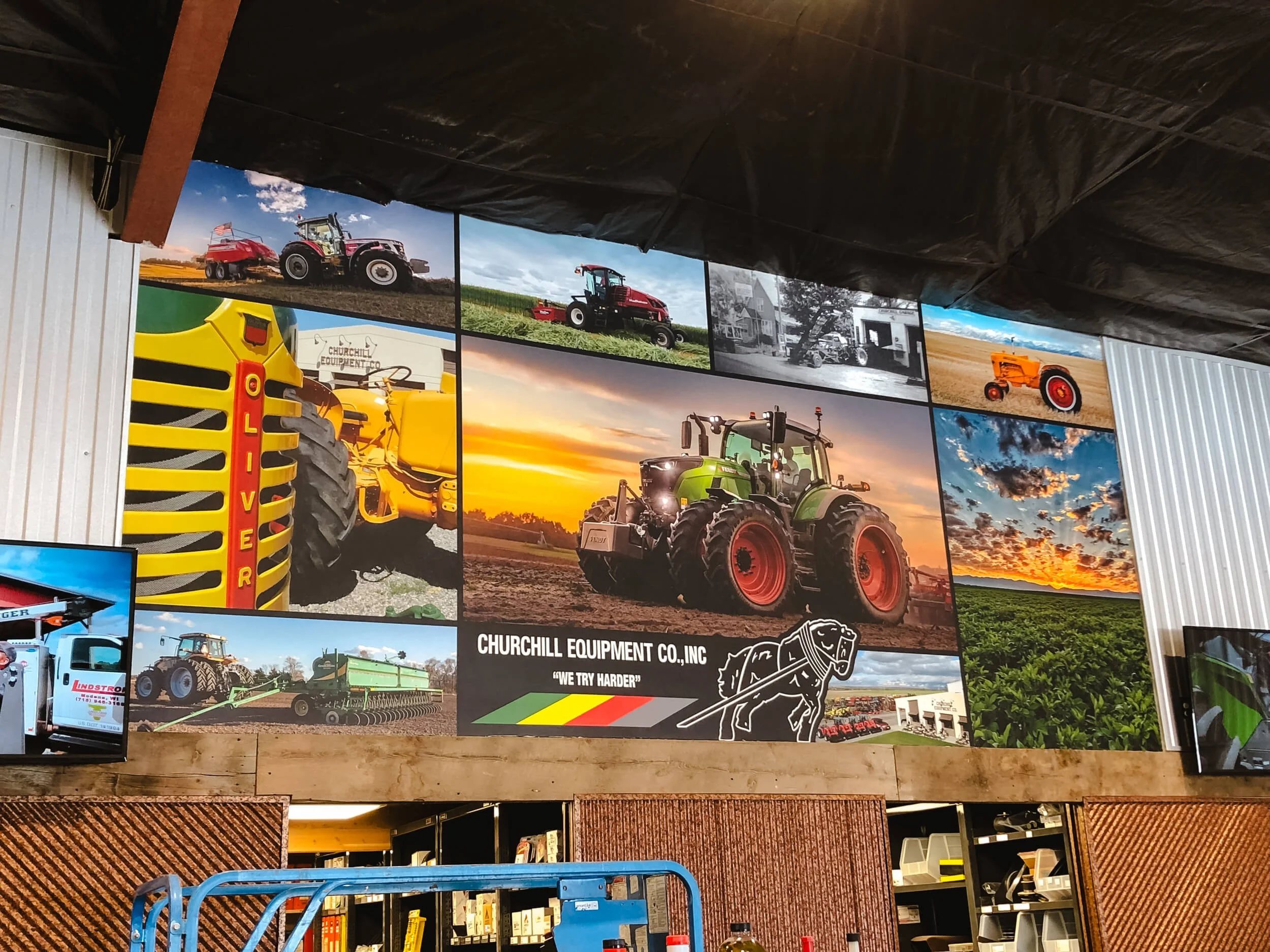 Custom photo collage wall wrap for an equipment dealership, displaying vibrant tractor imagery, brand logos, and agricultural scenes in a retail showroom – installed at Churchill Equipment Co in Manhattan, MT.