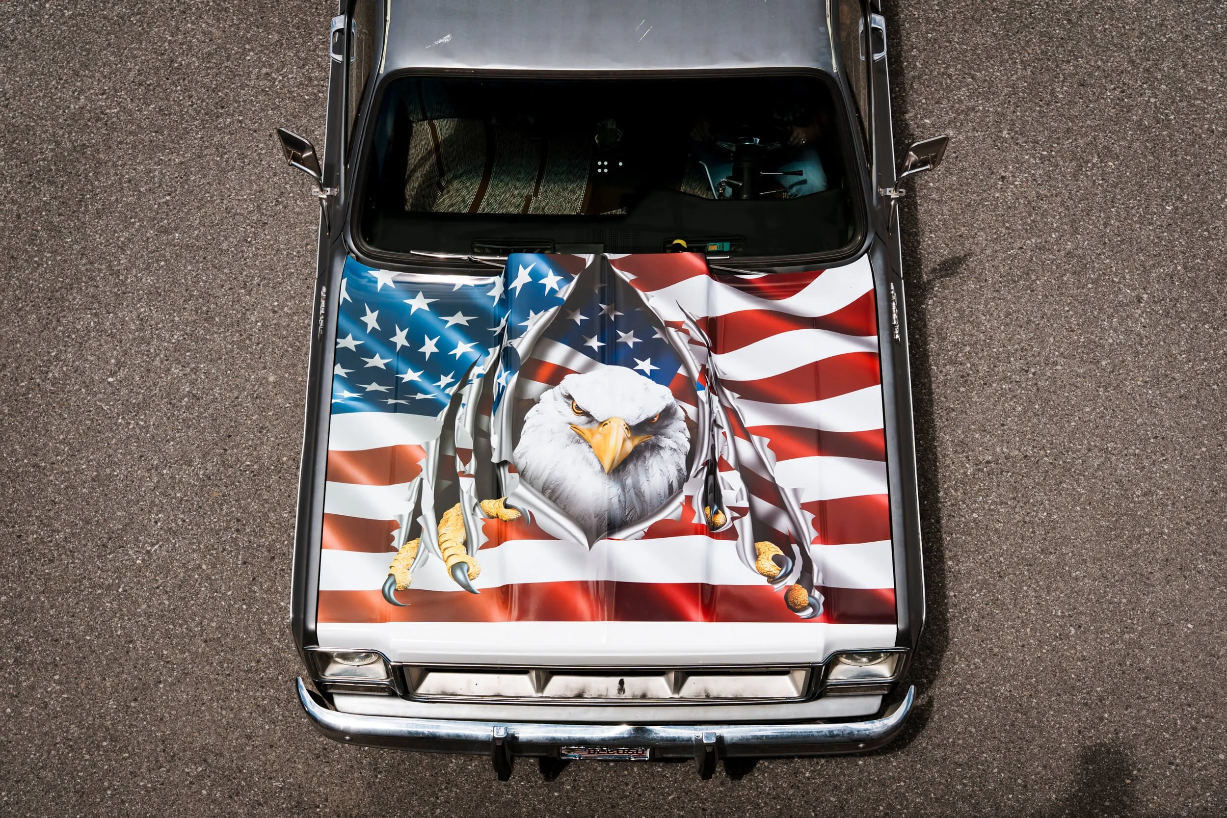 Overhead view of a hood wrap on a 1976 GMC truck with a large Bald Eagle clawing it's way through an American Flag