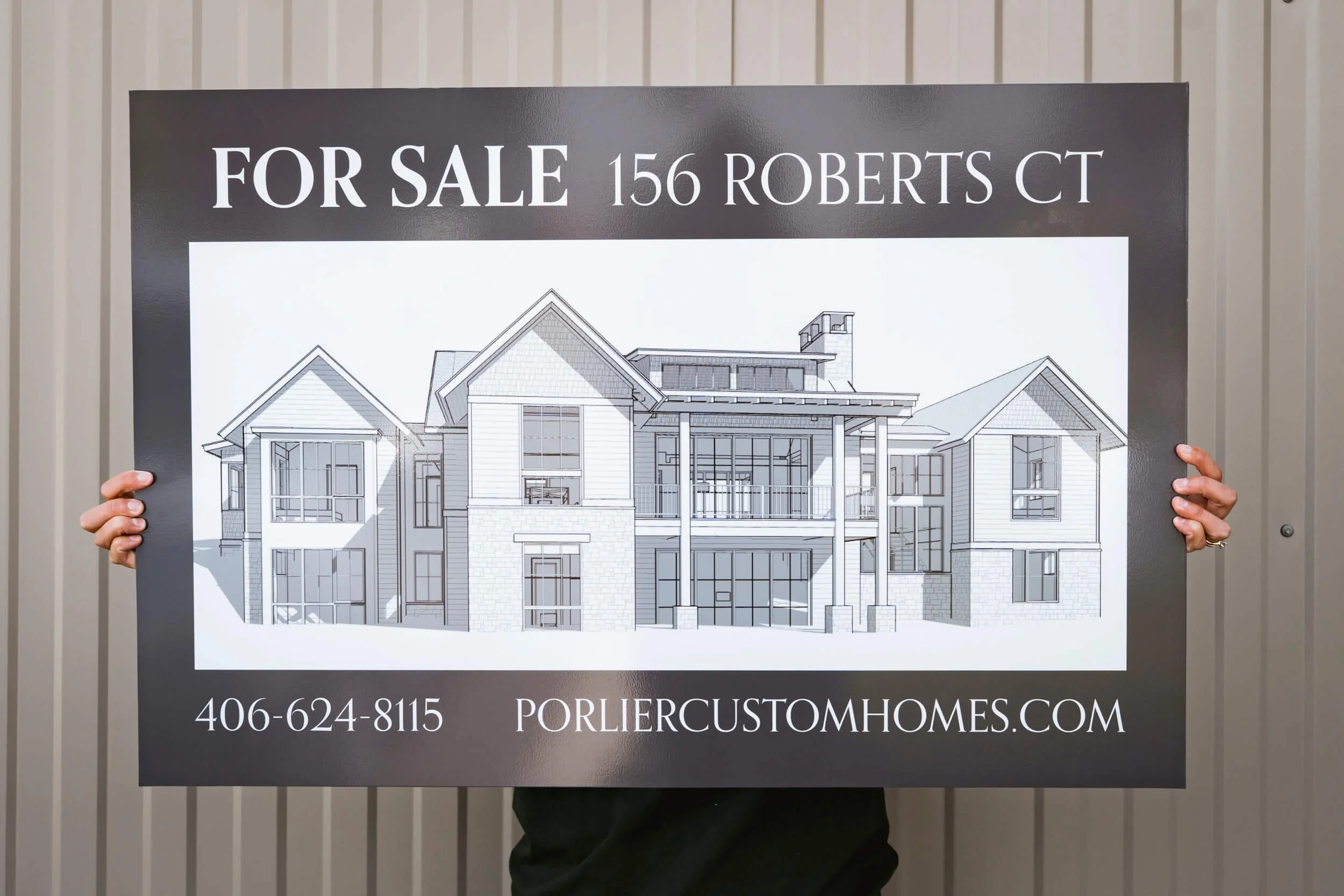 Custom sign for a custom Bozeman home by Porlier Custom Homes featuring a black and white rendering. 