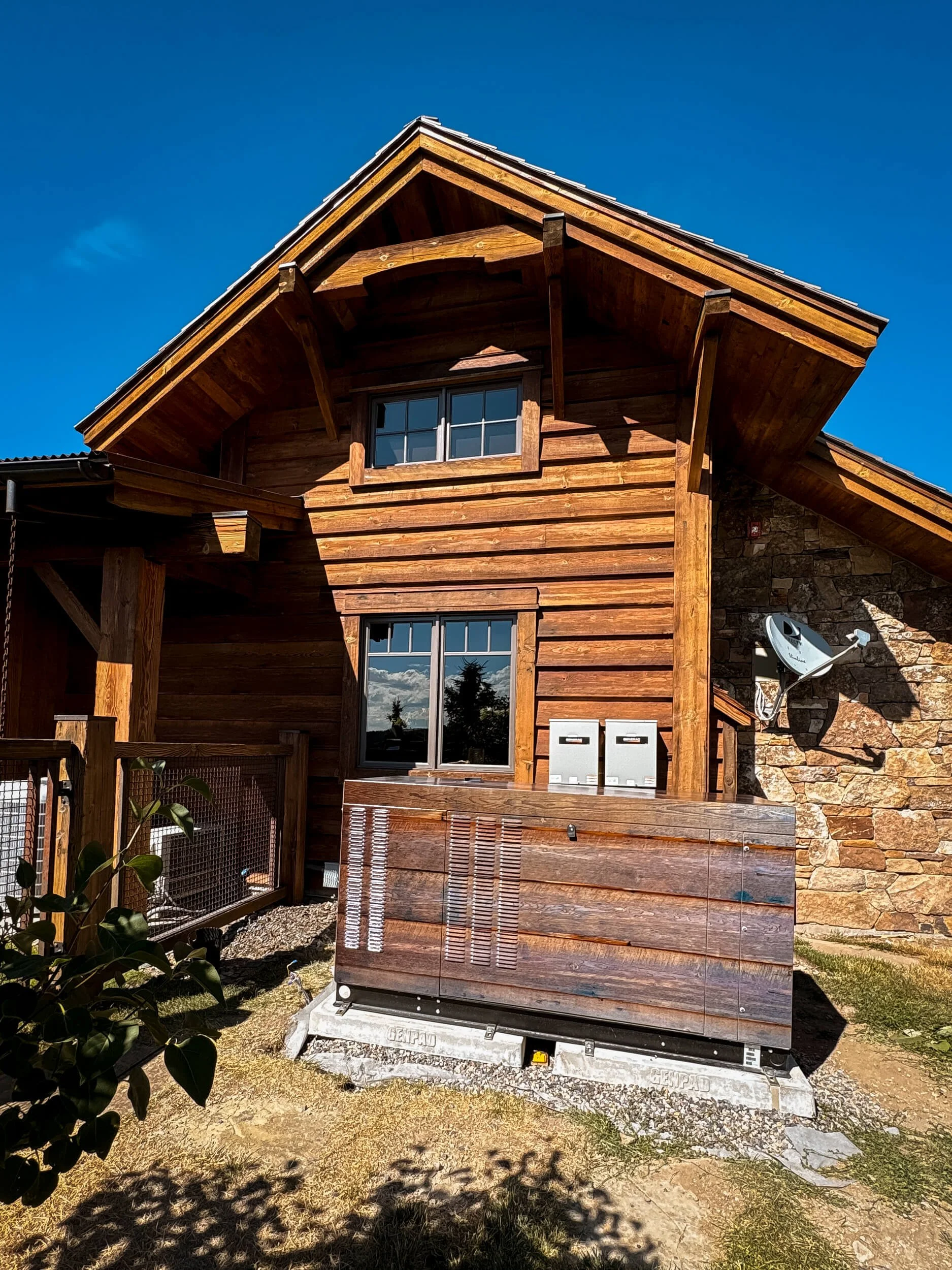 Vinyl wrapped generator with cedar paneling to match the siding of the house