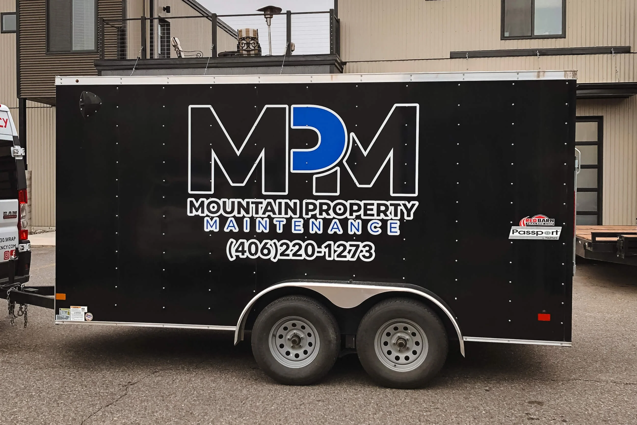 Bold MPM logo in black and blue on a black trailer
