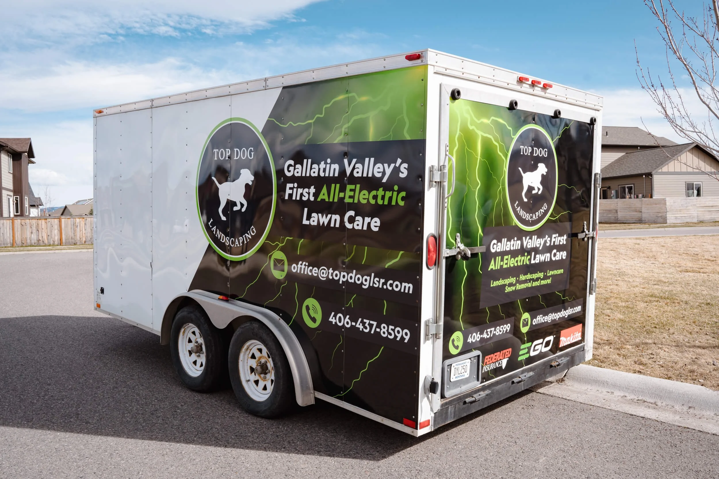 Black and green trailer wrap for Top Dog Landscaping in Bozeman, Montana, with lightning bolt graphics, company branding, and contact info promoting all-electric lawn care services.