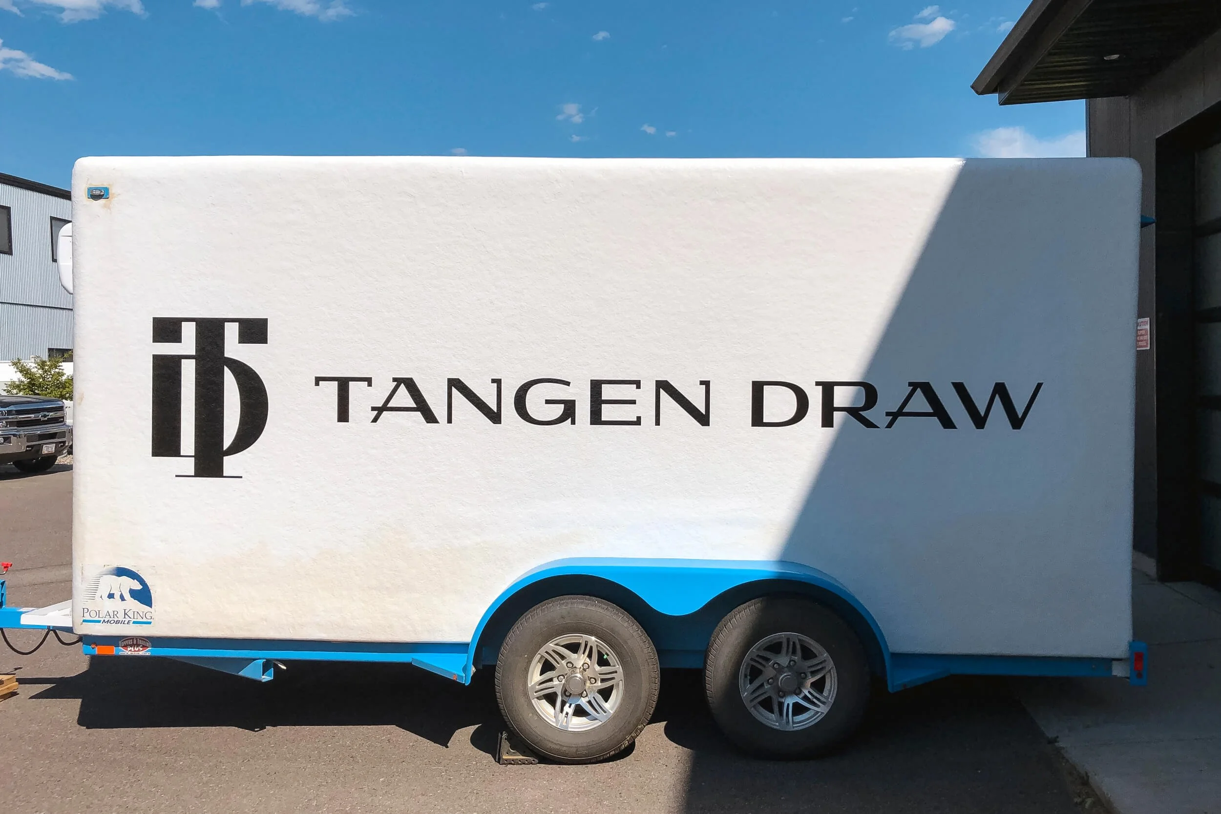 TD monogram and text in black vinyl on a white freezer trailer