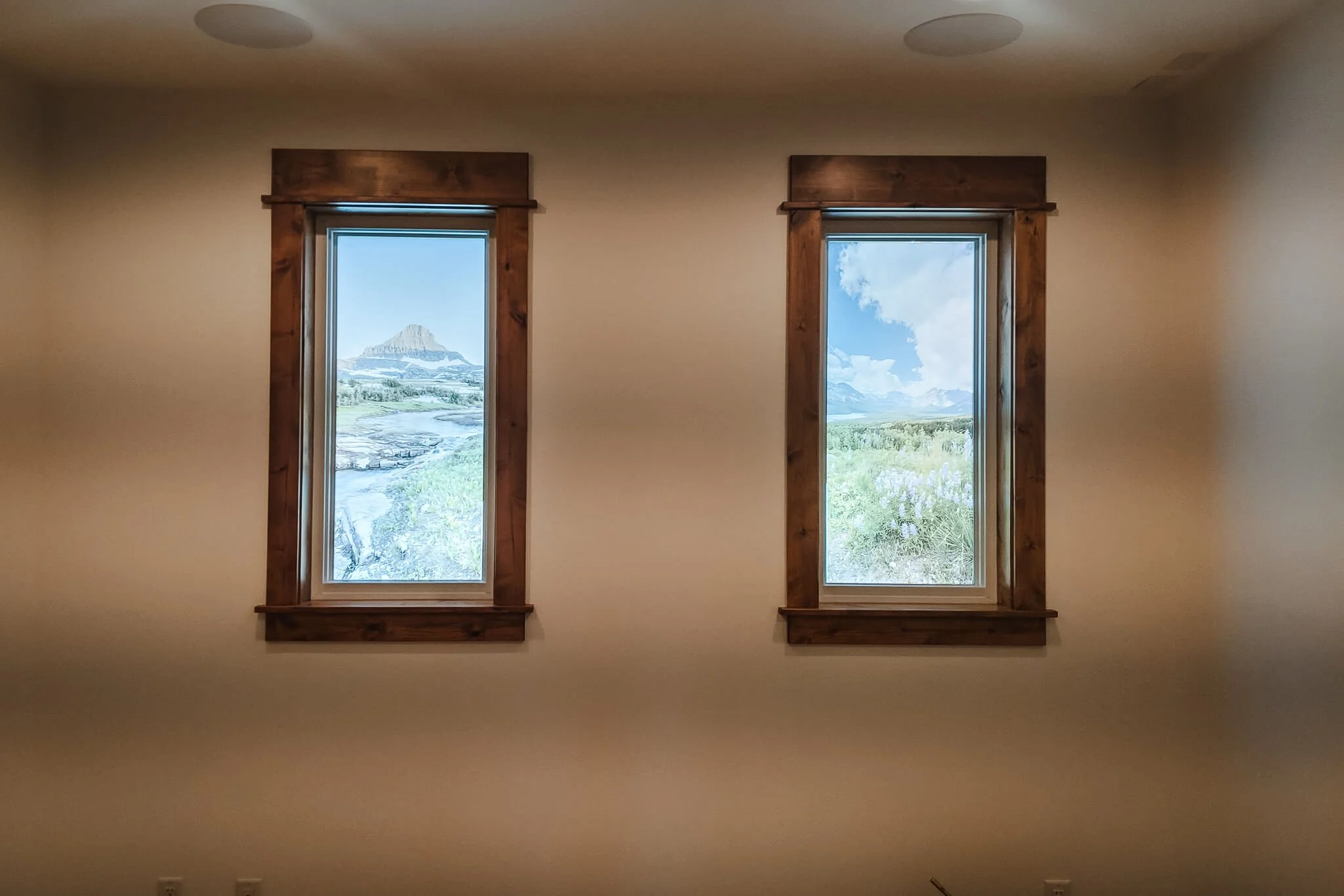 Residential window graphics printed with high-resolution landscape photography create the appearance of scenic outdoor views through two side-by-side windows.