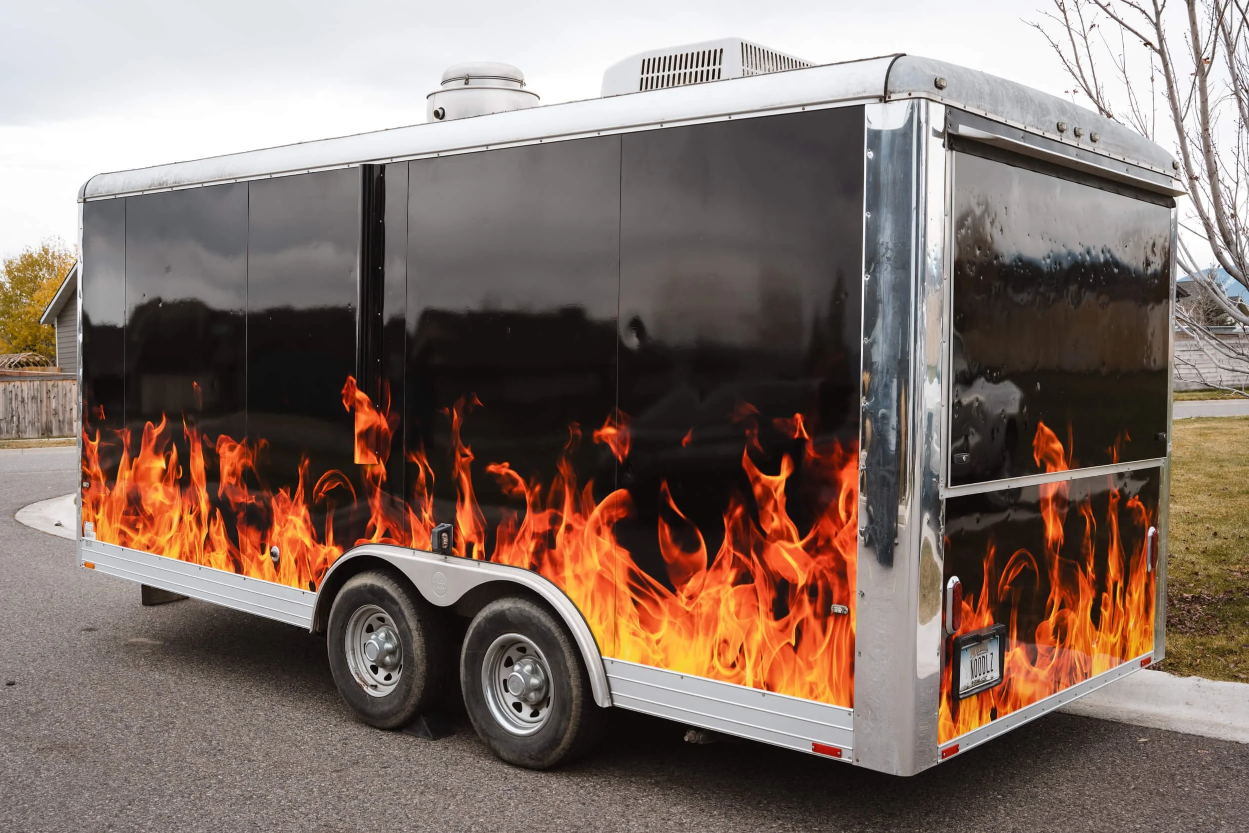 Food trailer with a full wrap of flames on a black background